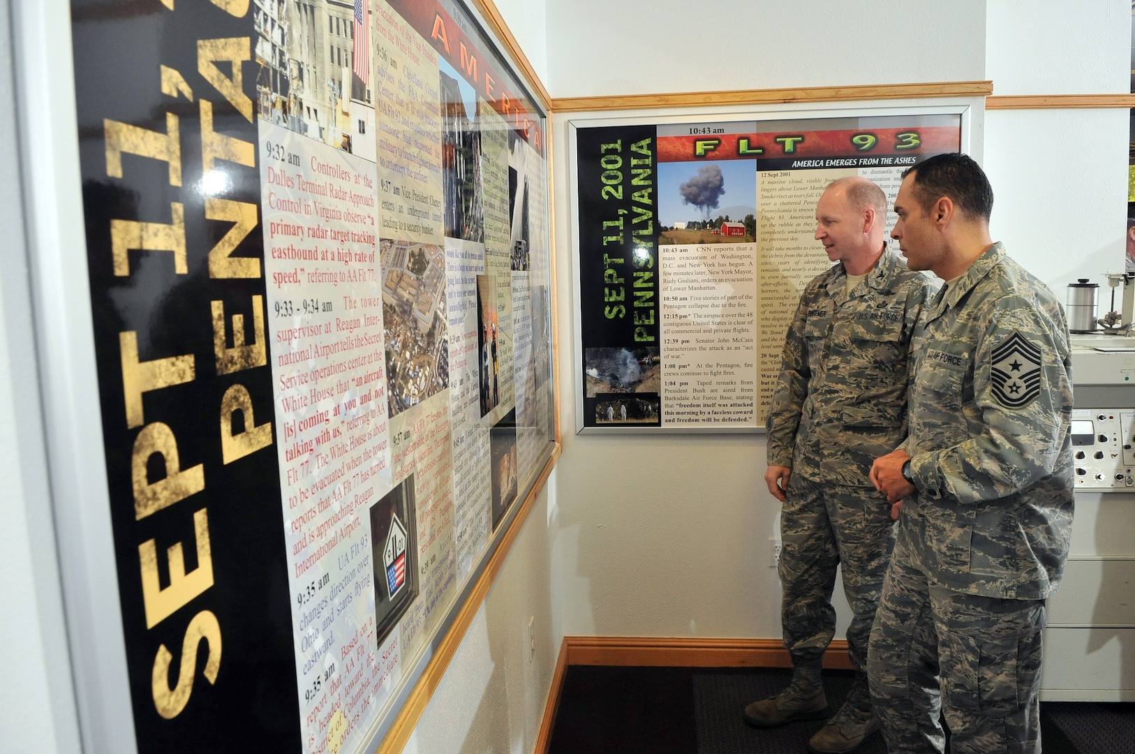 Col. John Bansemer, Air Force Intelligence, Surveillance and Reconnaissance
Agency assistant vice commander, and AFISRA Command Chief Master Sgt.
Frederick Ricker, pause to reflect Sept. 9 on the events of 9/11, as depicted on the commemorative panels in the agency's Heritage Center. (Photo by William Belcher) 
