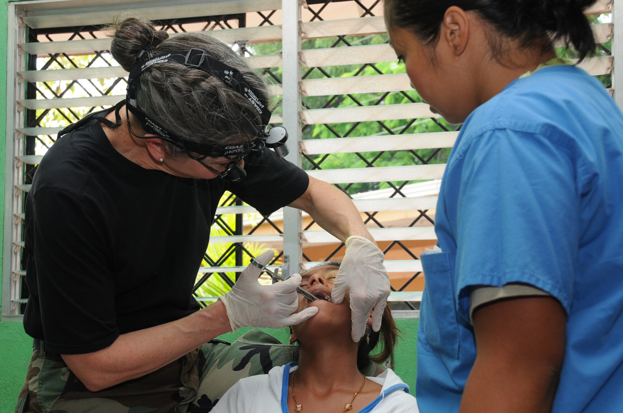 Lt. Col. Frances McClure, a dentist with the 916th Aerospace Medicine Squadron in North Carolina, numbs a patient prior to a tooth extraction here Aug. 8, 2011 as part of a humanitarian mission called a Medical Readiness Training Exercise (MEDRETE). The dental clinic pulled nearly 950 teeth during the two-week deployment. (USAF photo by Senior Airman Meredith A. H. Thomas, 916 ARW/PA)