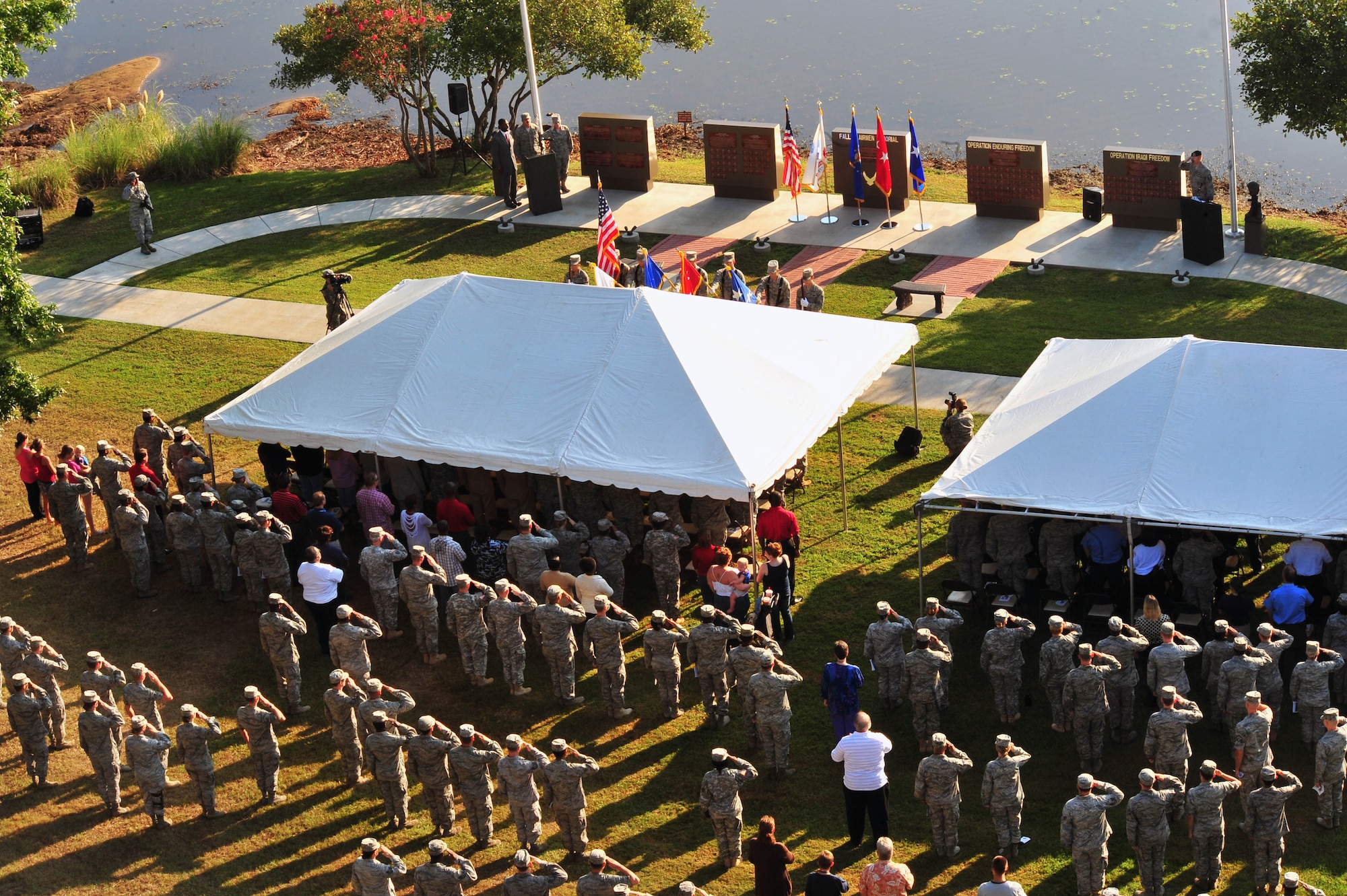 Team Shaw members salute as the Shaw Honor Guard present the Colors for the 9/11 Memorial Ceremony at Shaw Air Force Base S.C., Sept. 9, 2011. Hundreds of Team Shaw and local community members gathered together in remembrance of 9/11. (U.S. Air Force photo by Airman 1st Class Ashley Gardner/ Released)