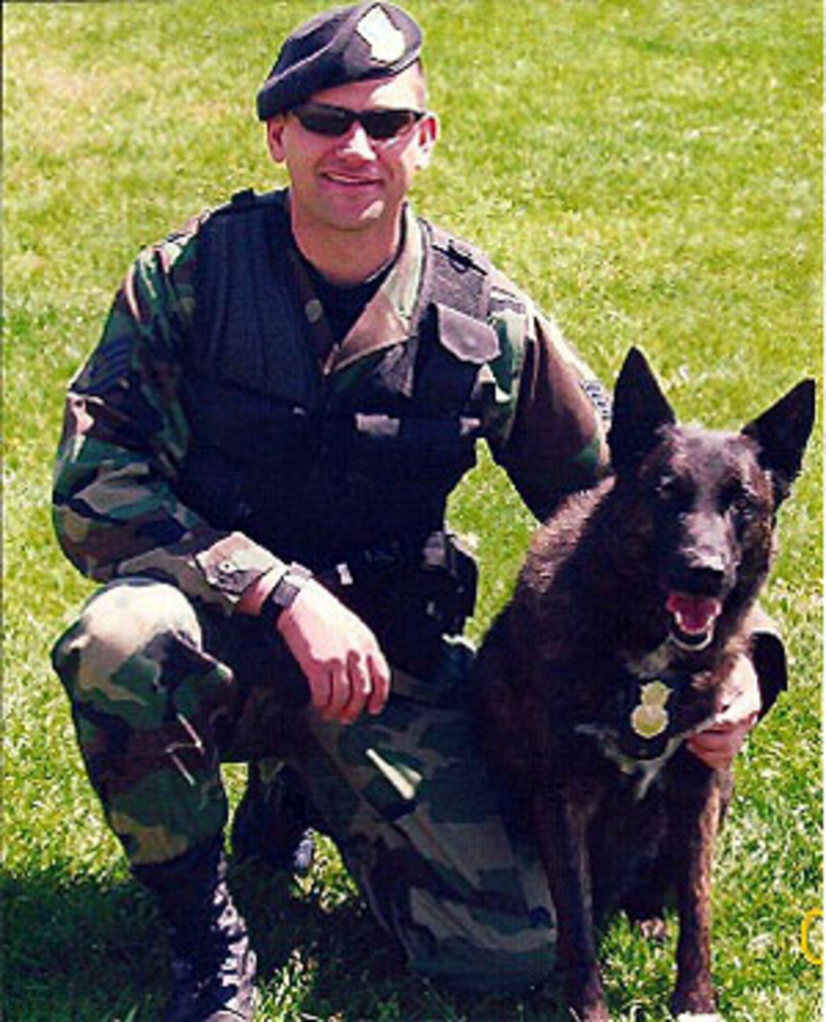 Tech. Sgt. Nathan Stull, a Reservist with the 446th Security Forces Squadron, Joint Base Lewis-McChord, Wash., poses with Marco during their active-duty days at Hill Air Force Base, Utah. Stull has adopted the now-retired Marco and is working on arranging a proper memorial for the 14-year-old Marco when the time comes. (U.S. Air Force file photo)