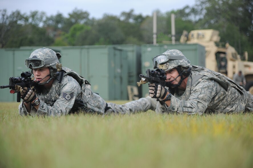 U.S. Air Force Staff Sgt. James Hicks, 823rd Base Defense Squadron (BDS) fireteam leader, left, and Maj. Gen. Stephen Hoog, 9th Air Force commander, look down their sights as they participate in drills at Moody Air Force Base, Ga., Sept. 8, 2011. The drills were to teach Hoog basic combat maneuvers before the beginning of a demonstration. When at home station, the 823rd BDS constantly trains as a highly capable and responsive force to the mission and can deploy at a moment’s notice. (U.S. Air Force photo by Airman 1st Class Paul Francis/Released)

