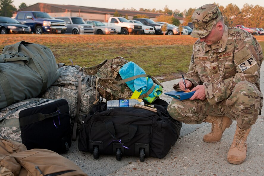 U.S. Air Force Maj. Robert Clouse, commander of the 721st Security Forces Squadron, fills out bag tags prior to departing Moody Air Force Base, Ga., for a deployment Sept. 9, 2011. Clouse is based out of Cheyenne Mountain Air Force Station, Co., and is attached to the 820th Base Defense Group during their deployment. (U.S. Air Force photo by Staff Sgt. Joshua J. Garcia/Released)