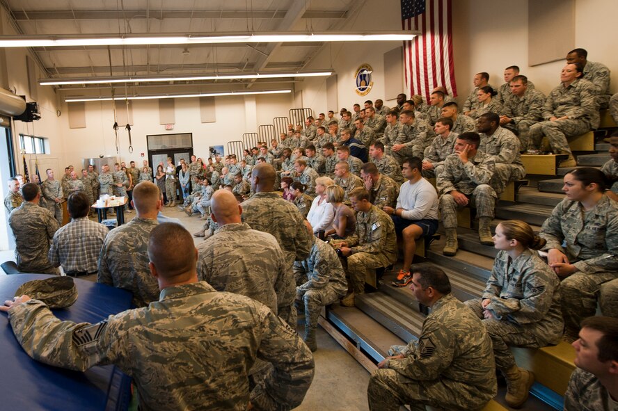 Members of the 820th Base Defense Group (BDG) listen to their commander, U.S. Air Force Col. Randall Richert, as he speaks to deploying members and their families at Moody Air Force Base, Ga., Sept. 9, 2011. Richert, who also deployed, headed to Afghanistan as part of a command element. The 820th BDG received a short-notice tasking to provide base defense  for service members stationed at Kandahar Air Base, Afghanistan. (U.S. Air Force photo by Staff Sgt. Joshua J. Garcia/Released)