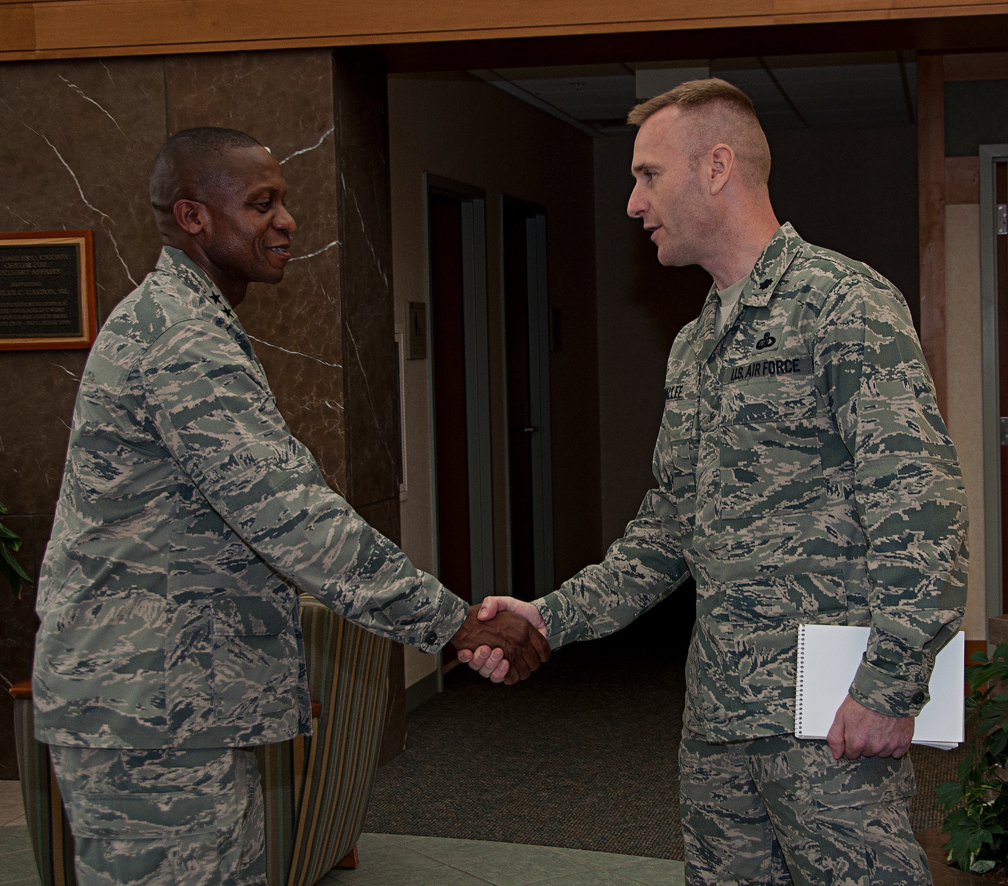Maj. Gen. Darren McDew, Air Force District of Washington commander, shakes the hand of Lt. Col. Christopher Lavallee while visiting the Charles C. Carson Center for Mortuary Affairs Sept. 8, 2011. McDew received a briefing on mortuary affairs and was given a tour of the facility. (U.S. Air Force photo/ Staff Sgt. Agustin Salazar)