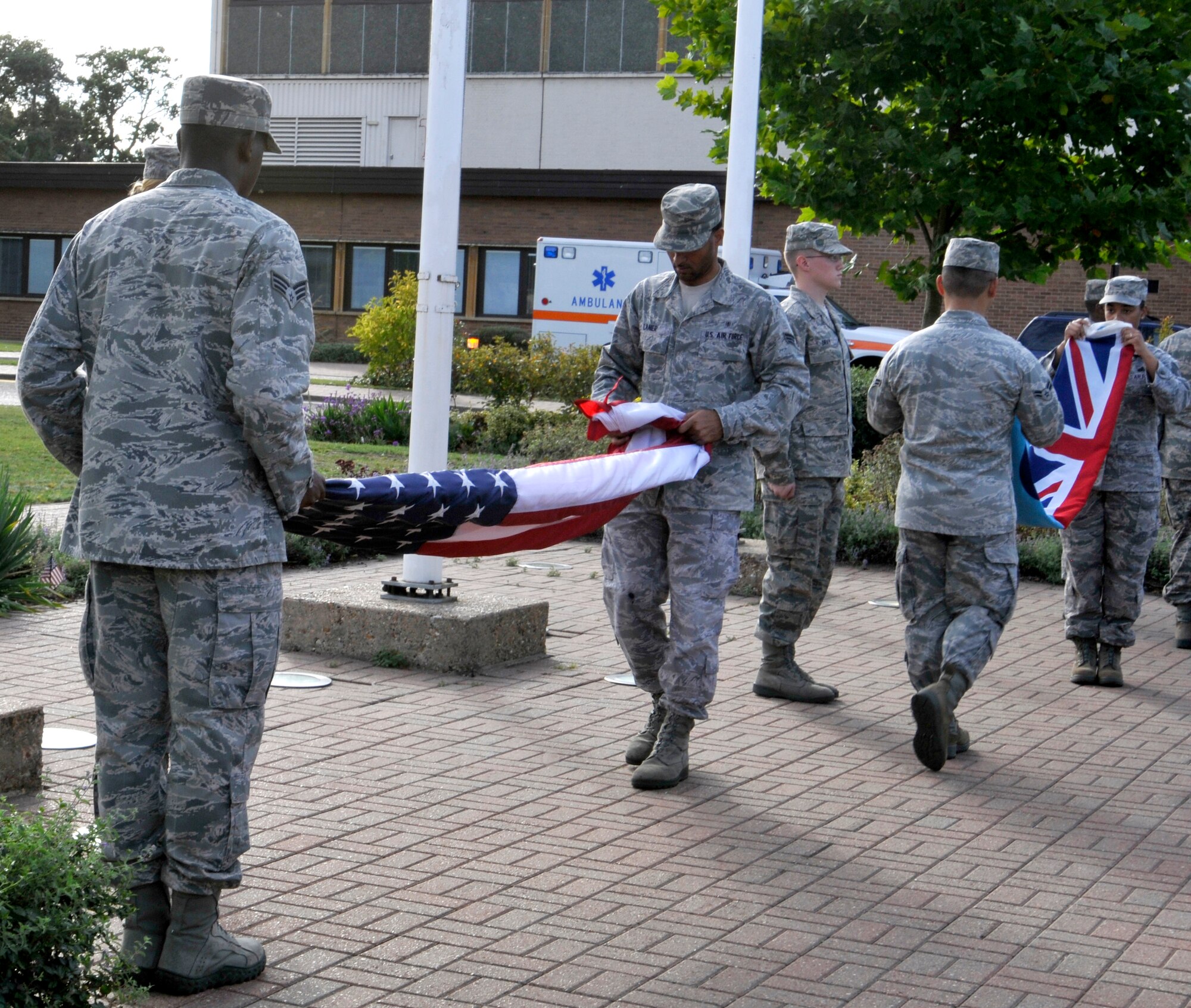 ROYAL AIR FORCE LAKENHEATH, England - Liberty Warriors fold the American flag and the British Royal Air Force flag during the 9/11 Remembrance Ceremony, Sept. 9, 2011. The ceremony was held to honor those that were lost in the attacks on Sept. 11, 2001. (U.S. Air Force photo by Senior Airman Tiffany M. Deuel)