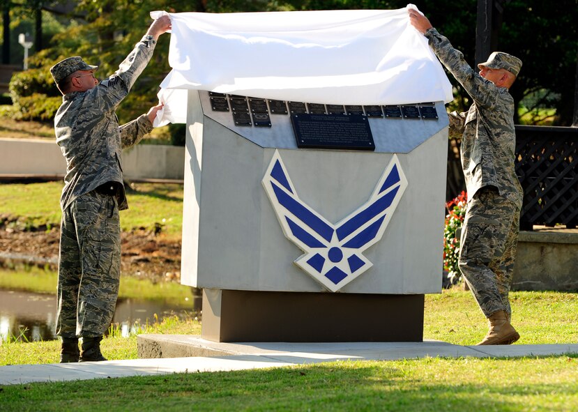 U.S. Air Force Master Sgt. Thomas Wright (left) and Senior Master Sgt. Jerry Dire, both from the 20th Communications Squadron, unveil the U.S. Air Forces Central Fallen Airmen Memorial during the ceremony in remembrance of 9/11 at Memorial Lake Park, Shaw Air Force Base, S.C., Sep. 9, 2011. The Fallen Airmen Memorial comes from the 332nd Air Expeditionary Wing, Balad Air Base, Iraq. The 332nd AEW memorial represents Air Force Central Command Airmen who served in Iraq and made the ultimate sacrifice for their nation. (U.S. Air Force photo by Tech Sgt. Louis Rivers/Released).