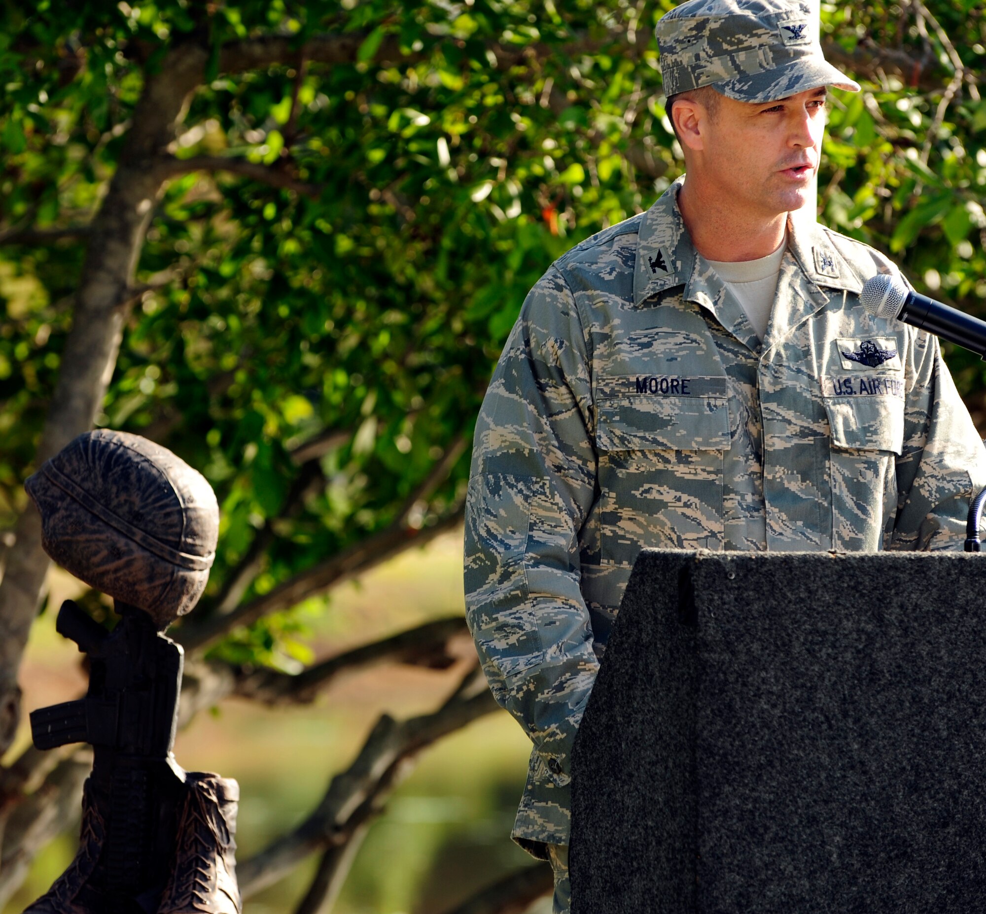 U.S. Air Force Col. Charlie Moore, 20th Fighter Wing commander, presents closing remarks at the conclusion of Team Shaw's 9/11 Remembrance Ceremony at Memorial Lake Park, Shaw Air Force Base, S.C., Sep. 9, 2011. Hundreds of Team Shaw and local community members gathered here for the ceremony to honor those lost ten years ago. (U.S. Air Force photo by Tech. Sgt. Louis Rivers/Released)