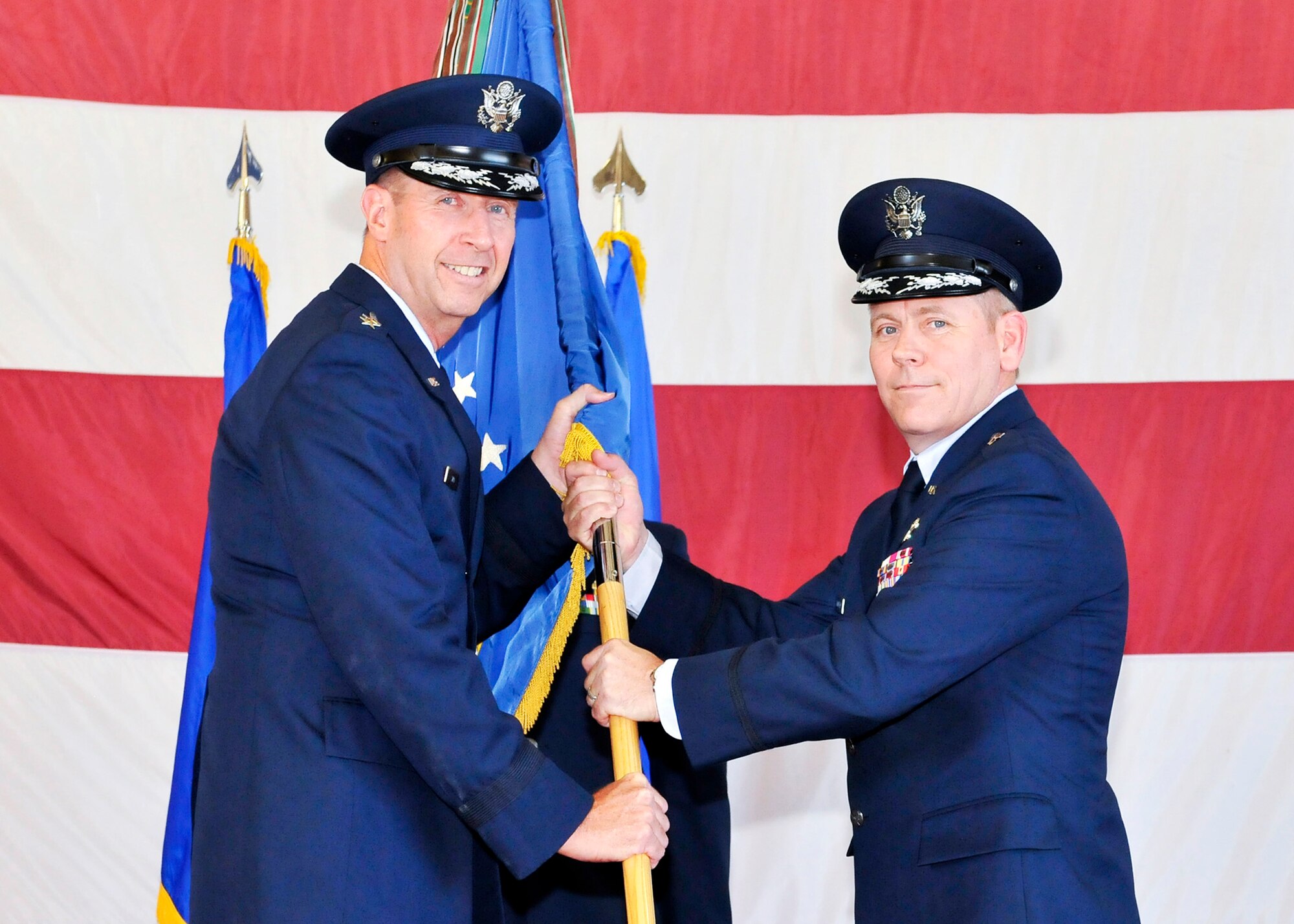 Major Gen. Mark S. Solo, 19th Air Force commander, Randolph Air Force Base, Texas, passes command of the 325th Fighter Wing to Brig. Gen. John K. McMullen during a change of command ceremony Sept. 9. General McMullen replaces Brig. Gen. James S. Browne, who departs Tyndall to serve as the Director of Operations for Air Force Global Strike Command, Barksdale Air Force Base, La. General McMullen arrives from Joint Base Elmendorf-Richardson, Alaska, where he served as the 3rd Wing commander. (U.S. Air Force photo by Lisa Norman) 

