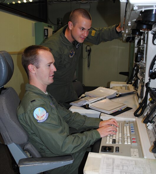 1st Lts. Matthew Ditson, sitting, and John Malek practice possible scenarios in the missile procedures trainer. The pair of missileers will represent the 490th Missile Squadron in the Global Strike Challenge. (U.S. Air Force photo/Airman 1st Class Katrina Heikkinen)
