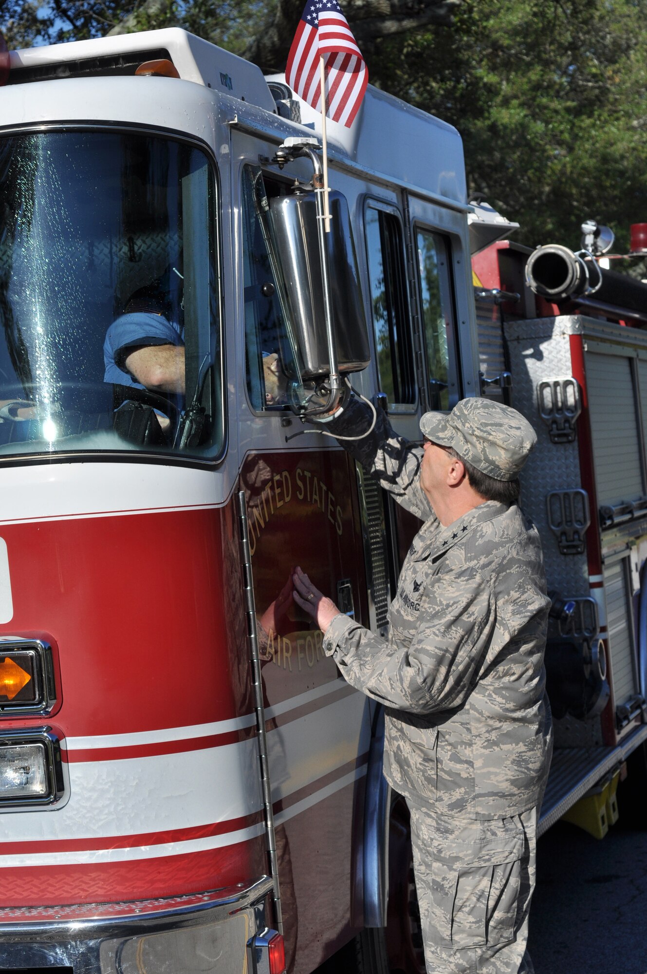 Lt. Gen. Charles E. Stenner, Jr., commander Air Force Reserve Command, thanks members of the Robins Air Force Base Fire Department for their role in delivering the 9/11 Pentagon stone from the AFRC headquarters building to the Museum of Aviation. The stone, an artifact from the 9/11 attack on the Pentagon, is a symbol of the sacrifices of thousands of American men and women who gave their lives on 9/11. In a show of respect, base employees lined the streets as the stone was delivered from Headquarters Air Force Reserve Command to the Museum of Aviation for the ceremony. (U.S. Air Force photo/Chief Master Sgt. Bill Goben) 
