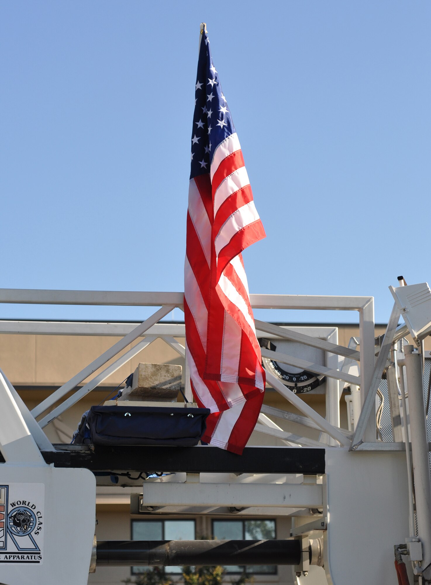 The Pentagon stone, secured on the Robins Air Force Base Fire Department ladder truck, is an artifact from the 9/11 attack on the Pentagon and a symbol of the sacrifices of thousands of American men and women who gave their lives on 9/11. In a show of respect, base employees lined the streets as the stone was delivered by the fire department from Headquarters Air Force Reserve Command to the Museum of Aviation for a 9/11 commemoration ceremony. (U.S. Air Force photo/Chief Master Sgt. Bill Goben)