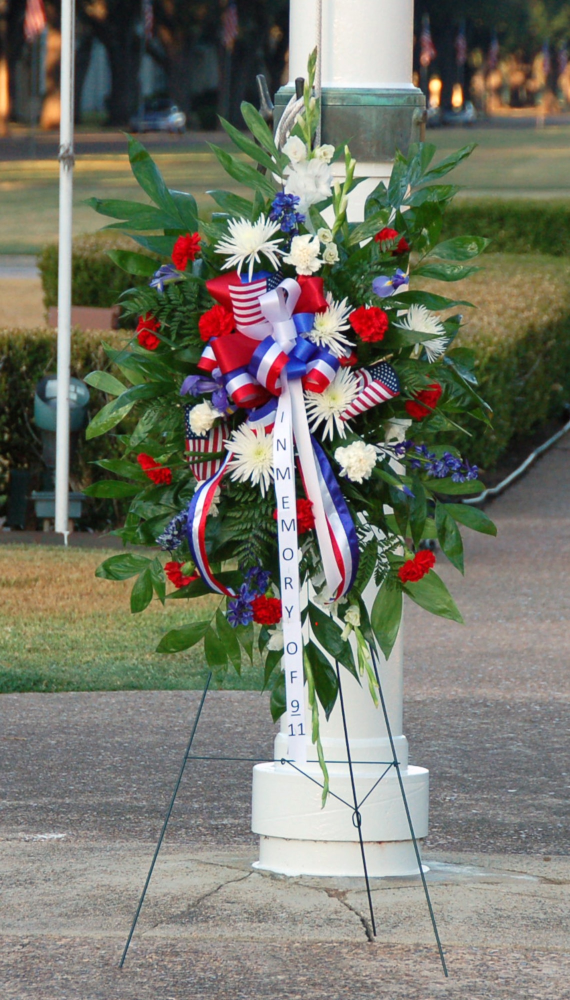 BARKSDALE AIR FORCE BASE, La. – Brig. Gens. Keith Kries, mobilization assistant to the Eighth Air Force commander, and John Mooney III, 307th Bomb Wing commander, walk to place a memorial wreath at the base of the 2nd Bomb Wing Headquarters flag pole during a 9/11 Reveille and Wreath Laying Ceremony on Barksdale Air Force Base Sept. 9, 2011. The ceremony included a moment of silence, which allowed Barksdale Airmen to reflect upon the tragic losses of Sept. 11, 2001, as well as the service and sacrifices made combating terrorism since that fateful day. (U.S. Air Force photo by Maj. Richard Komurek)