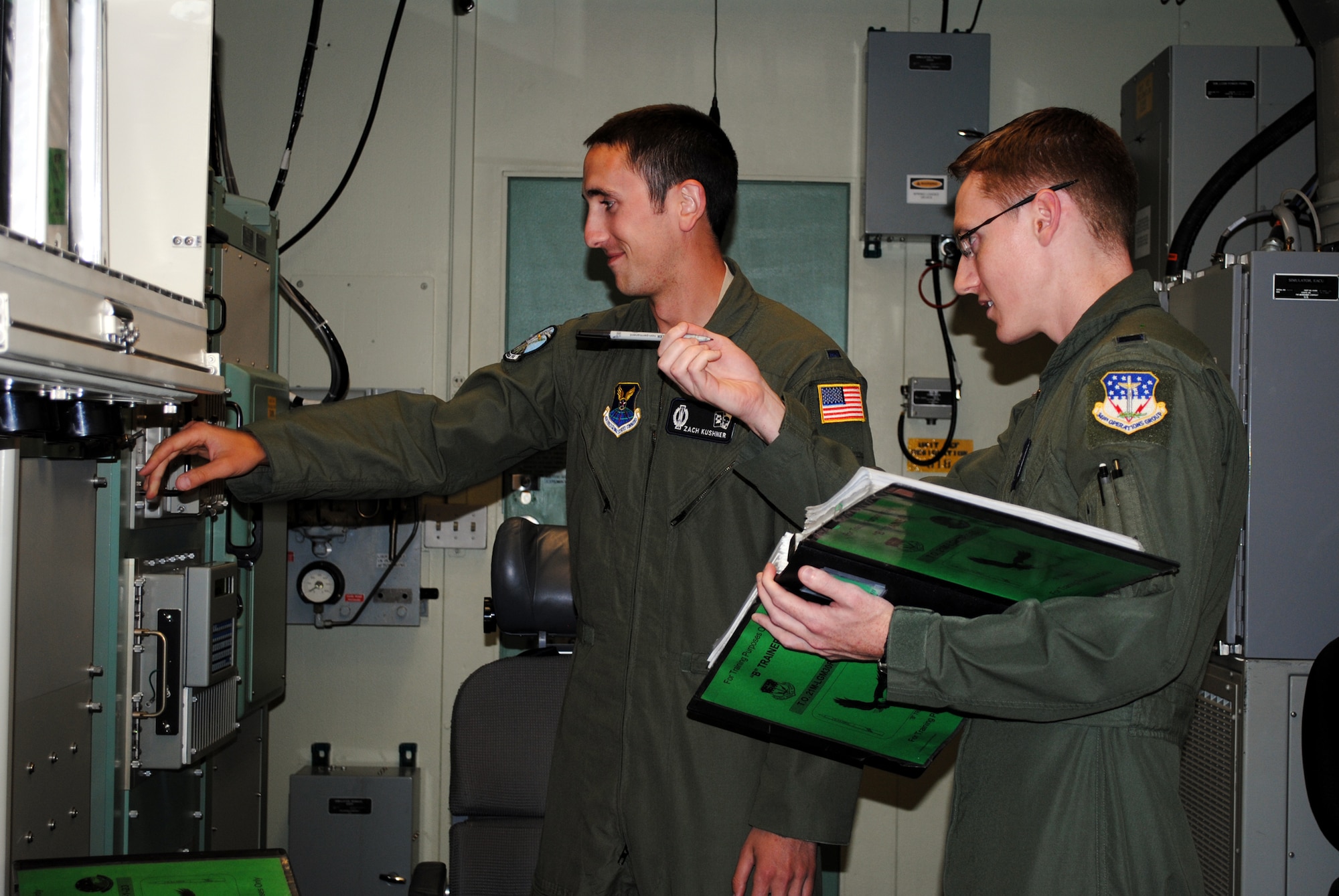 Selected from the 12th MS is 1st Lt. Zachary Kushner, checking light bulbs in the missile procedures trainer, while 1st Lt. Adam Hamlin reads him a checklist. (U.S. Air Force photo/Airman 1st Class Katrina Heikkinen)