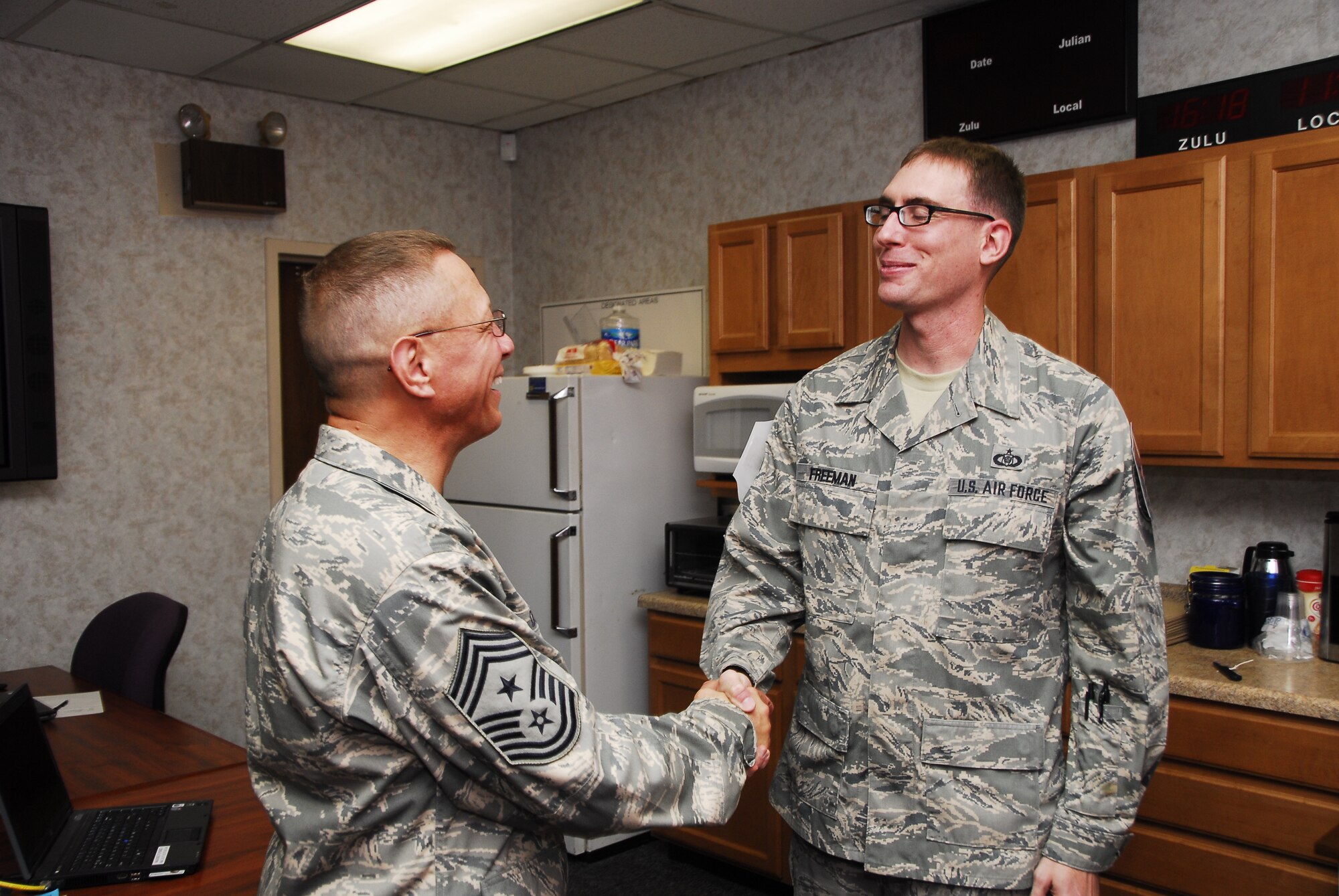 Recently selected 908th Command Chief Master Sgt. Owen Duke congratulates newly promoted Master Sgt. Michael Freeman of the 908th Command Post. Promotions to staff and master sergeant will be ‘highly scrutinized’ to ensure advancement of quality personnel.
