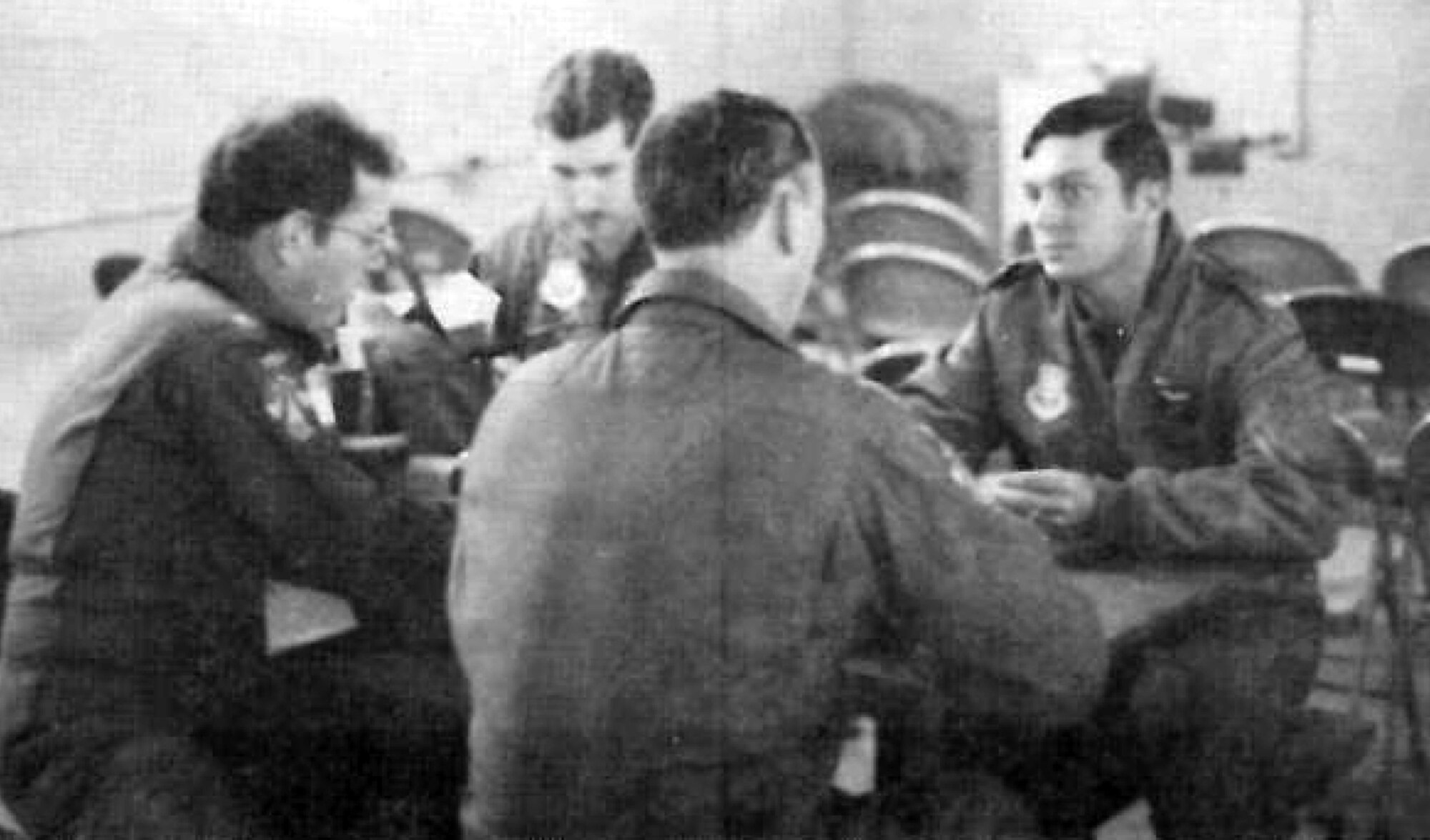 With other members of his flight, (l. to r.) Maj Wingerter, Lt Potts and Maj Cupp, Capt Logan plans a range mission. 