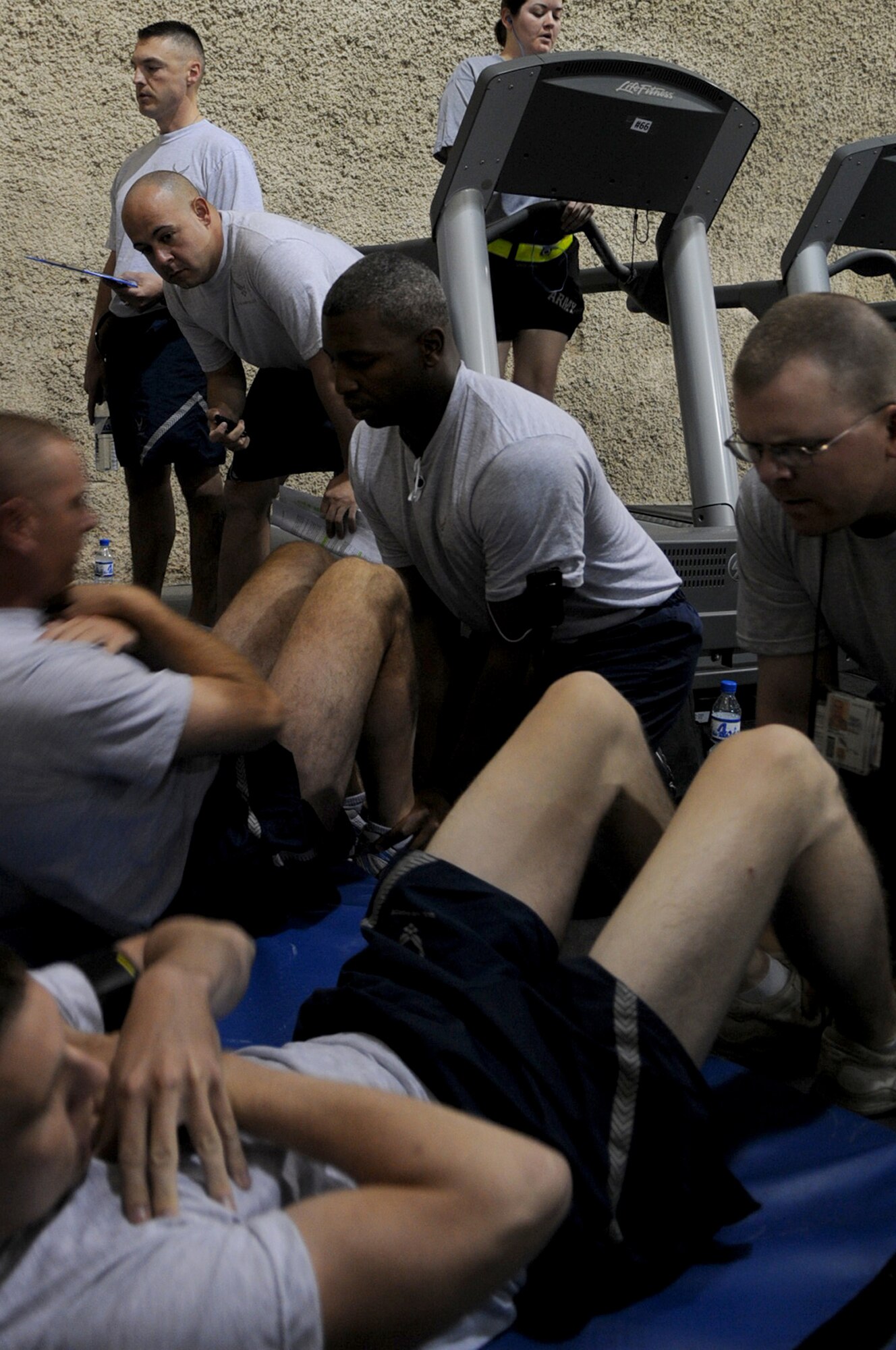 BAGRAM AIRFIELD, Afghanistan -- Master Sgt. Steven Brettler, 455th Expeditionary Force Support Squadron services flight chief, conducts a physical fitness assessment for members of the 455th Air Expeditionary Wing at the Rock Fitness Center in Camp Cunningham Sept. 8, 2011. Brettler is stationed at Joint Base Pearl Harbor-Hickam, Hawaii, and is a native of Brooklyn, N.Y. (U.S. Air Force photo/ Senior Airman Krista Rose)