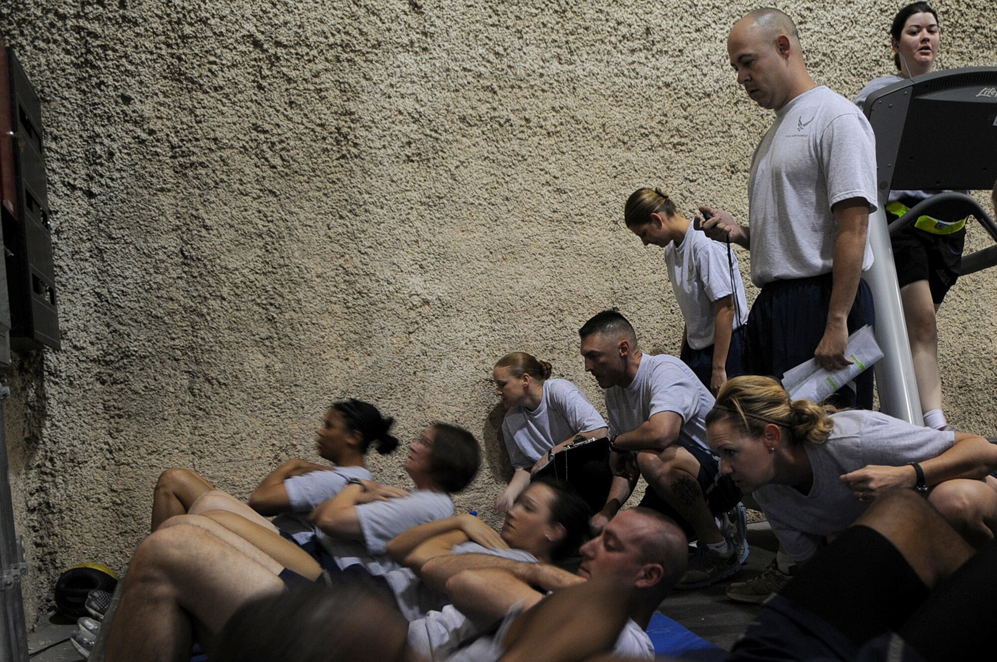 BAGRAM AIRFIELD, Afghanistan -- Master Sgt. Steven Brettler, 455th Expeditionary Force Support Squadron services flight chief, conducts a physical fitness assessment for members of the 455th Air Expeditionary Wing at the Rock Fitness Center in Camp Cunningham Sept. 8, 2011. Brettler is stationed at Joint Base Pearl Harbor-Hickam, Hawaii, and is a native of Brooklyn, N.Y. (U.S. Air Force photo/ Senior Airman Krista Rose)