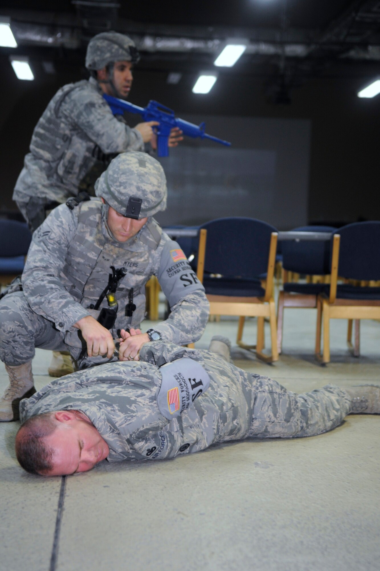 Airman 1st Class Cody Myers handcuffs Master Sgt. Donald Tipton, an active shooter role-player, during a training exercise at the Transit Center at Manas, Kyrgyzstan, Sept. 8. During the exercise Tipton was a “disgruntled Airman” who went on a simulated shooting spree in the passenger terminal here. Myers and Tipton are members of the 376th Expeditionary Security Forces Squadron. Myers is a patrolman deployed here from Cheyenne Mountain, Colo. Tipton is a logistics superintendent deployed here from McConnell Air Force Base, Kan. (U.S. Air Force photo/Tech. Sgt. Tammie Moore)