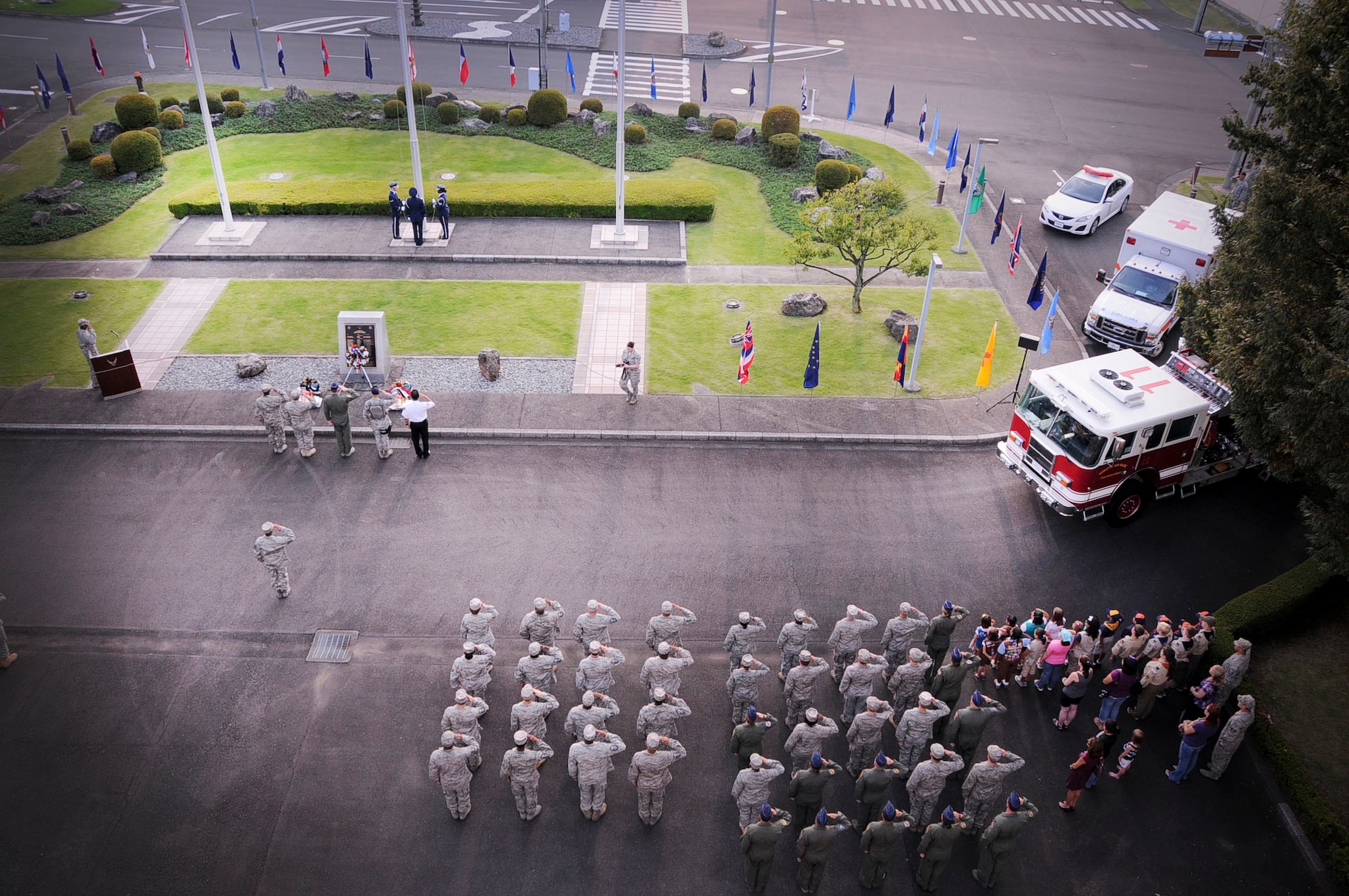 YOKOTA AIR BASE, Japan  -- Col. Otto Feather, 374th Airlift Wing commander, and  Airmen at Yokota Air Base, Japan, look on as members of the base honor guard retire the colors during the  9/11 retreat ceremony on Sept. 09, 2011. The ceremony acknowledged the courageous first responders and others who risked their lives to save the victims of Sept. 11, 2001, and service members who have joined the military since these events. (U.S. Air Force photo/Staff Sgt Stacy Moless)