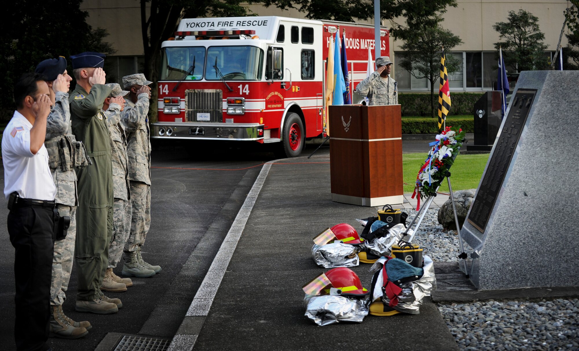 YOKOTA AIR BASE, Japan  -- Col. Otto Feather, 374th Airlift Wing commander, and  Airmen at Yokota Air Base, Japan, look on as members of the base honor guard retire the colors during the  9/11 retreat ceremony on Sept. 09, 2011. The ceremony acknowledged the courageous first responders and others who risked their lives to save the victims of Sept. 11, 2001, and service members who have joined the military since these events. (U.S. Air Force photo/Staff Sgt Stacy Moless)
