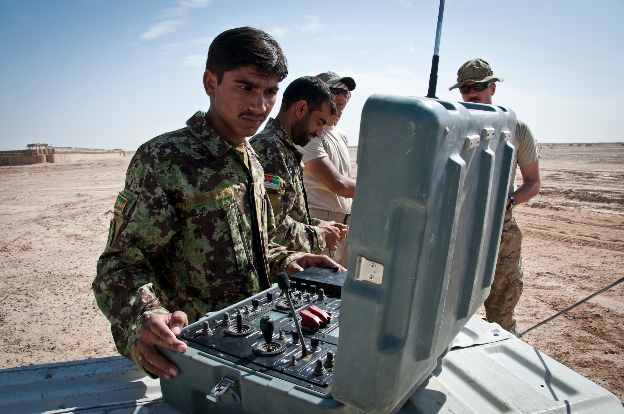 CAMP DWYER, Afghanistan -- A member of the Afghan National Army Explosive Ordnance Disposal team troubleshoots an issue with the EOD remote-controlled vehicle during a simulated improvise explosive device exercise at Camp Dwyer, Afghanistan, Sept. 4, 2011. Members of the 466th Air Expeditionary Squadron Explosive Ordnance Disposal charlie flight is training the ANA team on the most current counter-IED procedures to validate their EOD capabilities. (U.S. Air Force photo by Senior Airman David Carbajal)