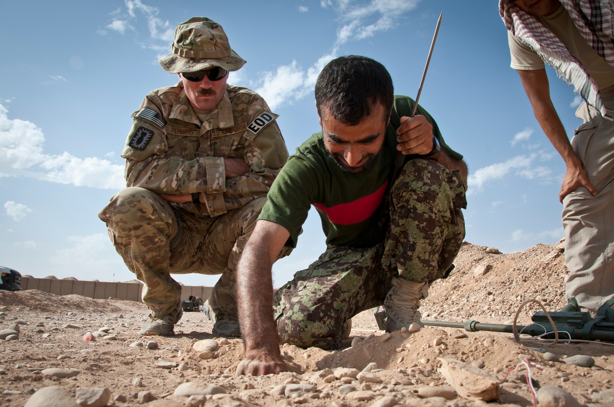 CAMP DWYER, Afghanistan -- Staff Sgt. Michael Perkins, 466th Air Expeditionary Squadron Explosive Ordnance Disposal charlie flight, looks over the counter improvised explosive device procedures of the Afghan National Army EOD team leader at Camp Dwyer, Afghanistan, Sept. 3, 2011. The Air Force EOD team is training the ANA team on the most current counter IED procedures to validate their EOD capabilities. (U.S. Air Force photo by Senior Airman David Carbajal)