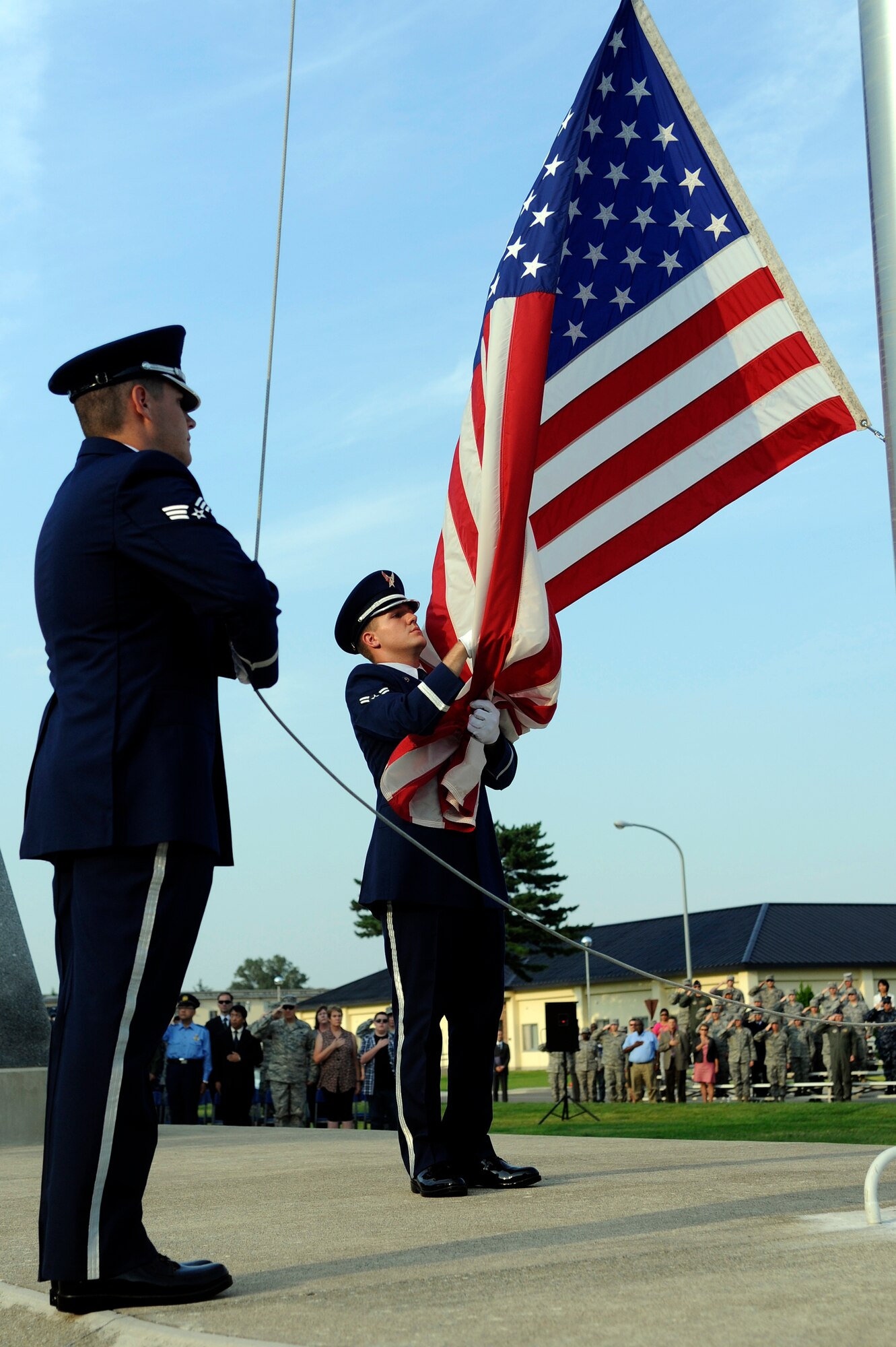 MISAWA AIR BASE, Japan - The Misawa Air Base honor guard lowers the flag during the Patriot Day ceremony held at the base flag pole here Sept. 9. This year marks the 10th anniversary of the terrorist attacks against the World Trade Center and Pentagon, which killed more than 2,000 people. (U.S. Air Force photo/Tech. Sgt. Marie Brown)