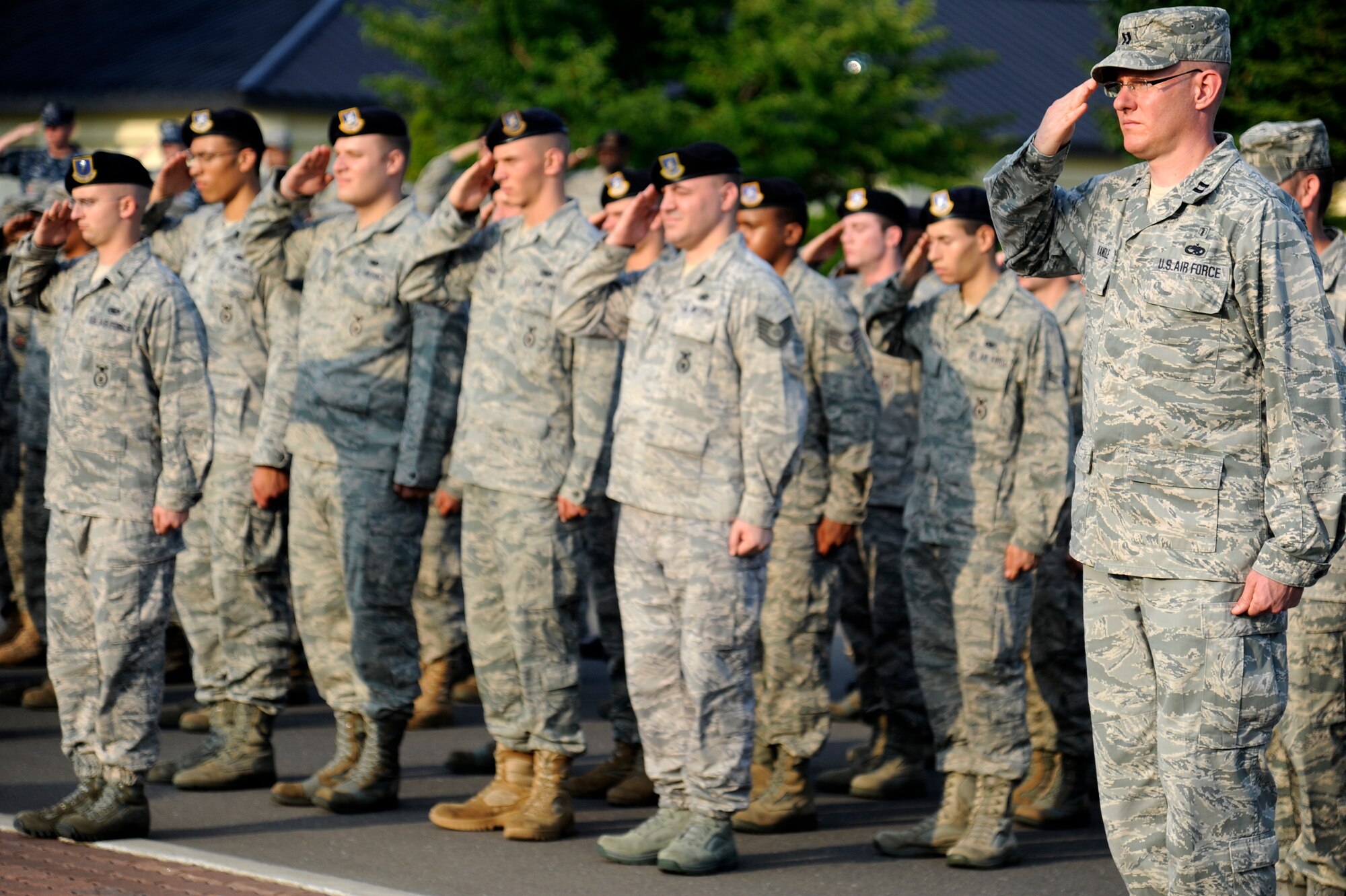 MISAWA AIR BASE, Japan -- During the Patriot Day ceremony here Sept. 9, Airmen with the 35th Security Forces Squadron, 35th Civil Engineer Squadron and 35th Medical Group stand in formation at the base flag pole to honor those who lost their lives on Sept. 11, 2001. This year marks the 10th anniversary of the terrorist attacks against the World Trade Center and Pentagon, which killed more than 2,000 people. (U.S. Air Force photo/Tech. Sgt. Marie Brown)