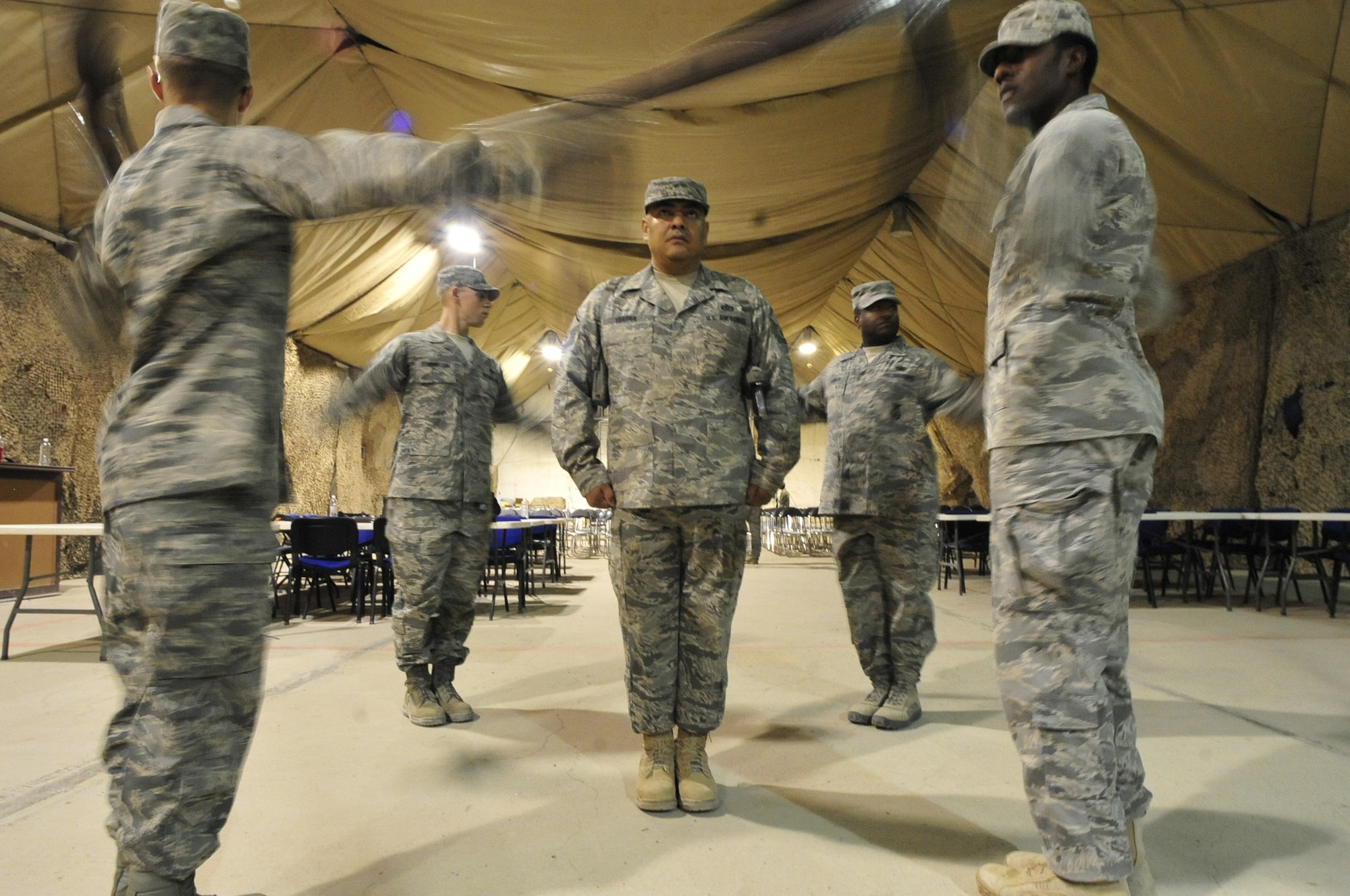 Master Sgt. Herman Ybarra stands in the middle of the four-man drill team Aug. 28, 2011, while his 407th Air Expeditionary Group Honor Guard practices for their 9/11 ceremony at Ali Base, Iraq. Sergeant Ybarra is deployed from Vandenberg Air Force Base, Calif., and is a native of Corpus Christi, Texas.  (U.S. Air Force photo/Master Sgt. Cecilio Ricardo)