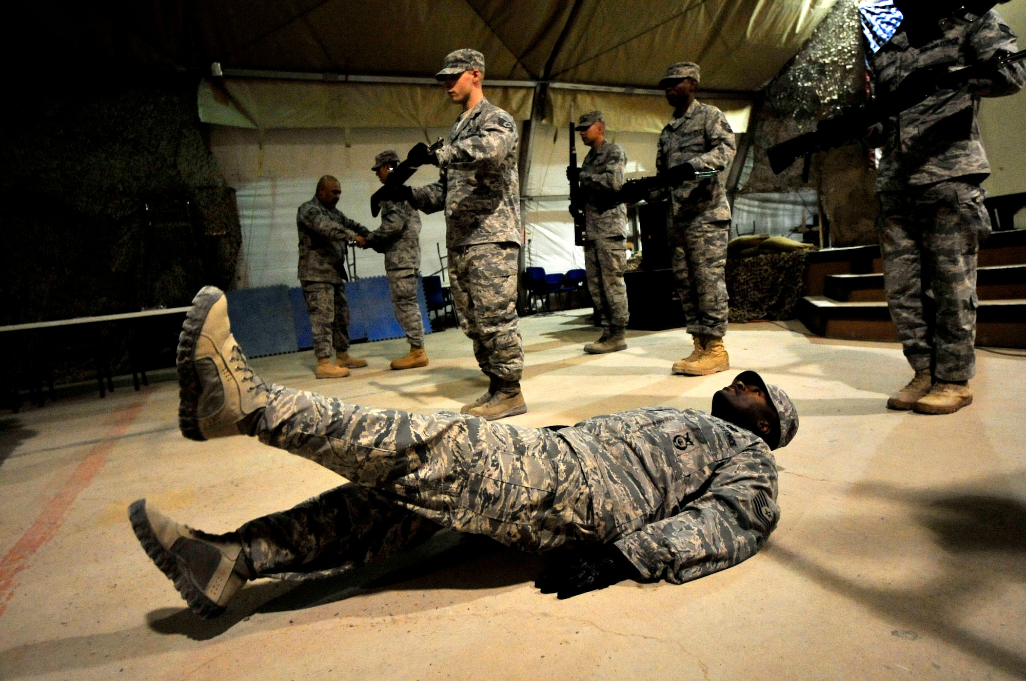 Tech. Sgt. Sean Hannah, 407th Security Forces Squadron NCO-in-Charge of operations, voluntarily performs flutter kicks Aug. 28, 2011, after dropping his rifle while practicing drill team movements in preparation for the 9/11 ceremony at Ali Base, Iraq.Sergeant Hannah is deployed from Hill Air Force Base, Utah, and a native of Mobile, Ala. (U.S. Air Force photo/Master Sgt. Cecilio Ricardo)