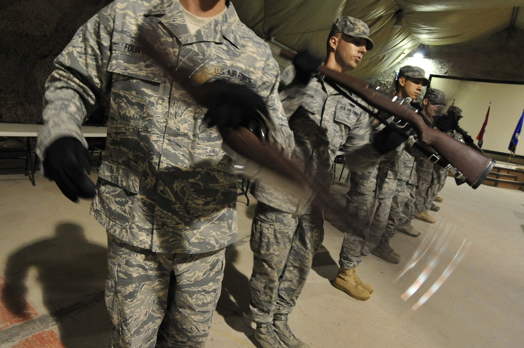 Senior Airman Christopher Fountain (left),  Airman 1st Class David Peterson and other members of the 407th Air Expeditionary Group Honor Guard  practice drill team techniques in preparation for a 9/11 ceremony on Ali Base, Iraq on Aug. 28, 2011. Airman Fountain is deployed from Creech Air Force Base, Nev.  Airman Peterson is deployed from Minot Air Force Base, N.D., and is a native of Tucson, Ariz. (U. S. Air Force photo/Master Sgt. Cecilio Ricardo)