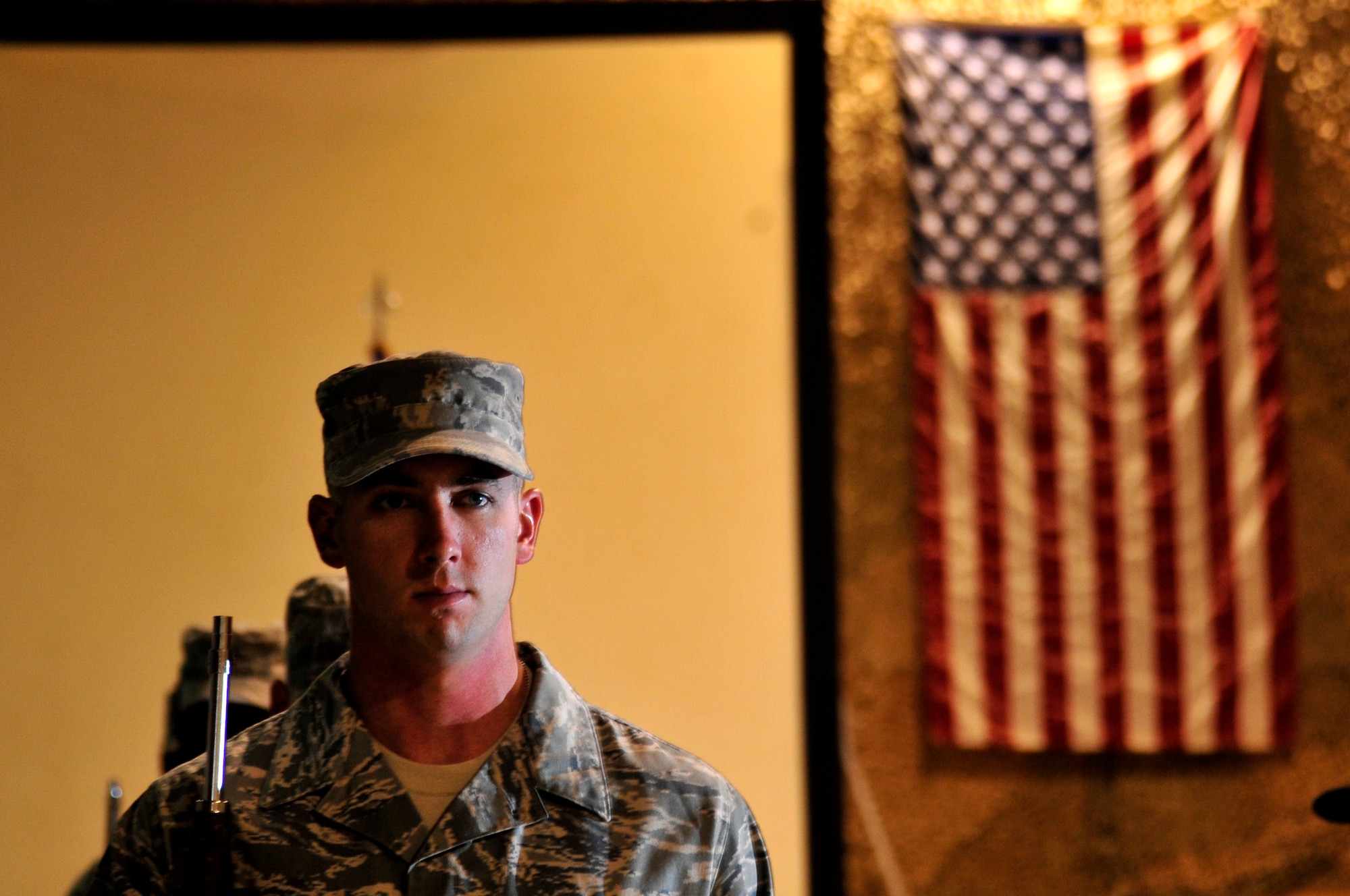 Senior Airman Christopher Fountain, 407th Air Expeditionary Group Honor Guard member, practices drill team techniques Aug. 28, 2011, in preparation for a 9/11 ceremony at Ali Base, Iraq. Airman Fountain is deployed from Creech Air Force Base, Nev. (U. S. Air Force photo/Master Sgt. Cecilio Ricardo)