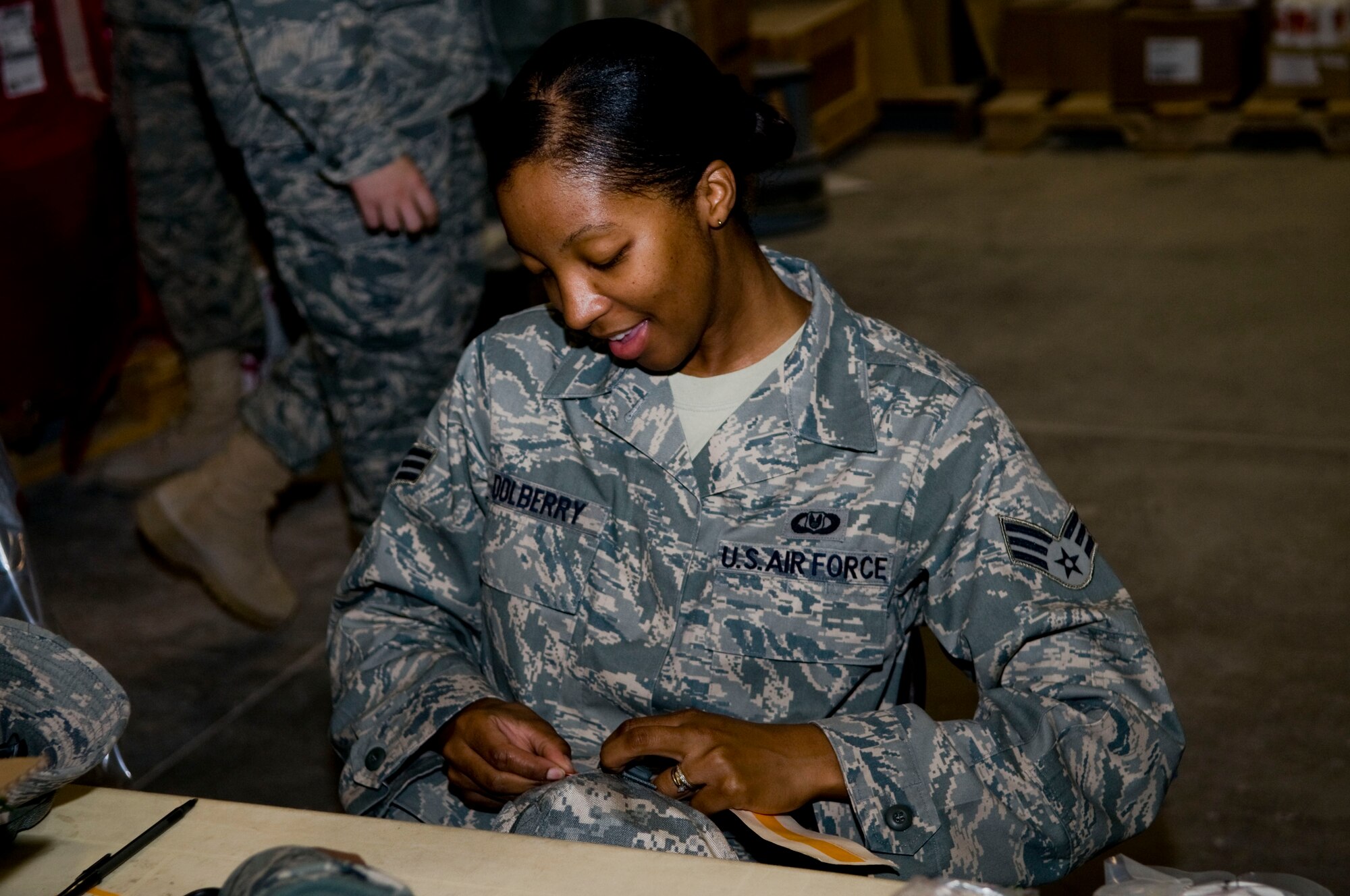 Senior Airman Canvis Dolberry, a volunteer from the 379th Expeditionary Operations Support Squadron, seals an individual first aid kit after replacing expired items within the kit, Aug. 24. Dolberry is a Reservist deployed from Pope Field, N.C. (U.S. Air Force photo/Senior Airman Eric Summers Jr.)