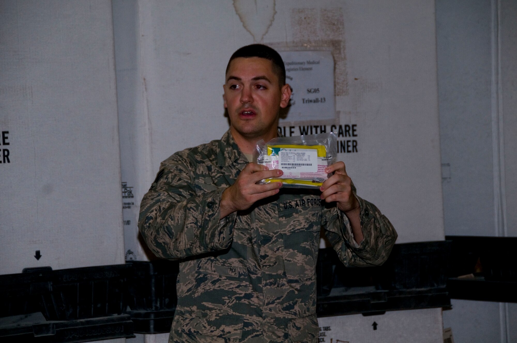 Senior Airman Joseph Rossilli, 379th Expeditionary Medical Group, describes the items that should be in every individual first aid kit during a mass IFAK rebuild, Aug. 24, at an undisclosed location in Southwest Asia. The 379th Air Expeditionary Wing is responsible for the certification and distribution of all IFAKS throughout the Area of Responsibility. (U.S. Air Force photo/Senior Airman Eric Summers Jr.)