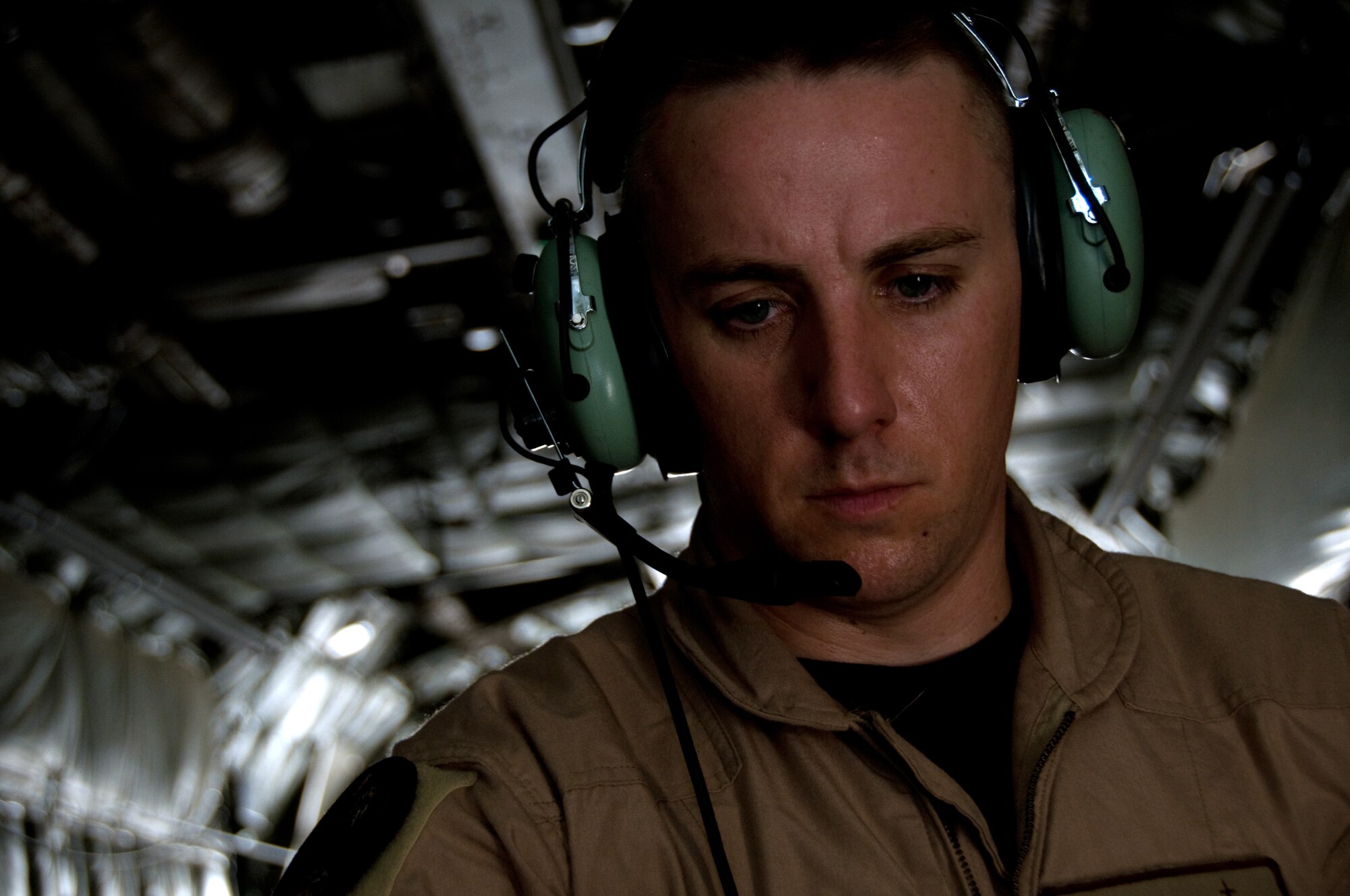 Master Sgt. Donnie Valentine, 379th Expeditionary Communications Squadron viper team, performs a communications check with equipment he and his team installed on a C-130 Hercules, Aug. 26. The viper team provides communications support, ranging from Internet access to telephones, for distinguished visitor flights throughout the Area of Responsibility.  (U.S. Air Force photo/Senior Airman Eric Summers Jr.)