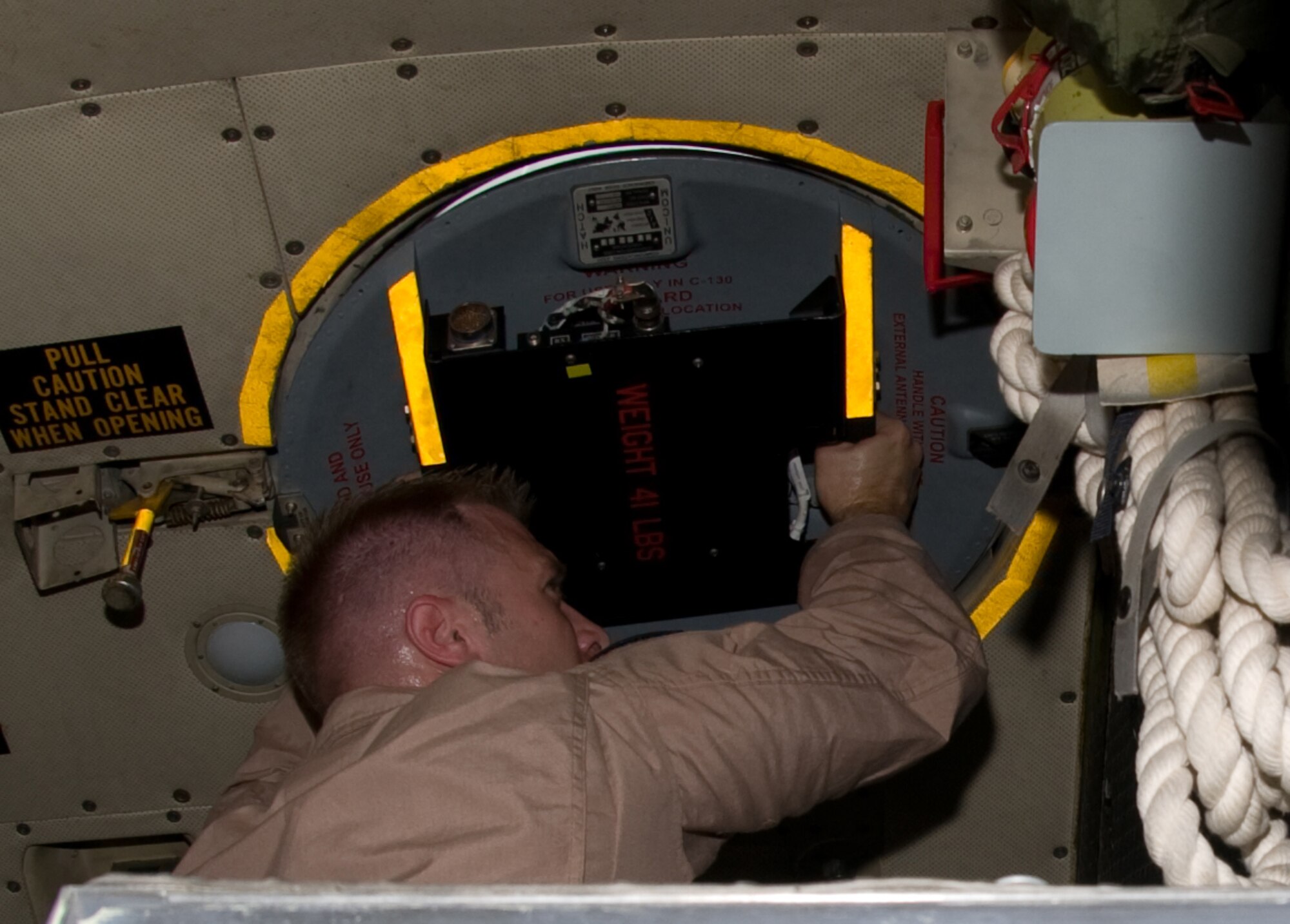 Tech. Sgt. Rocky Laprade, 379th Expeditionary Communications Squadron viper team member, attaches an EMS Viper International Maritime Satellite to the roof of a C-130 Hercules, Aug. 26. The viper team’s mission is to provide distinguished visitors with communications to help continue their mission while airborne. (U.S. Air Force photo/Senior Airman Eric Summers Jr.)