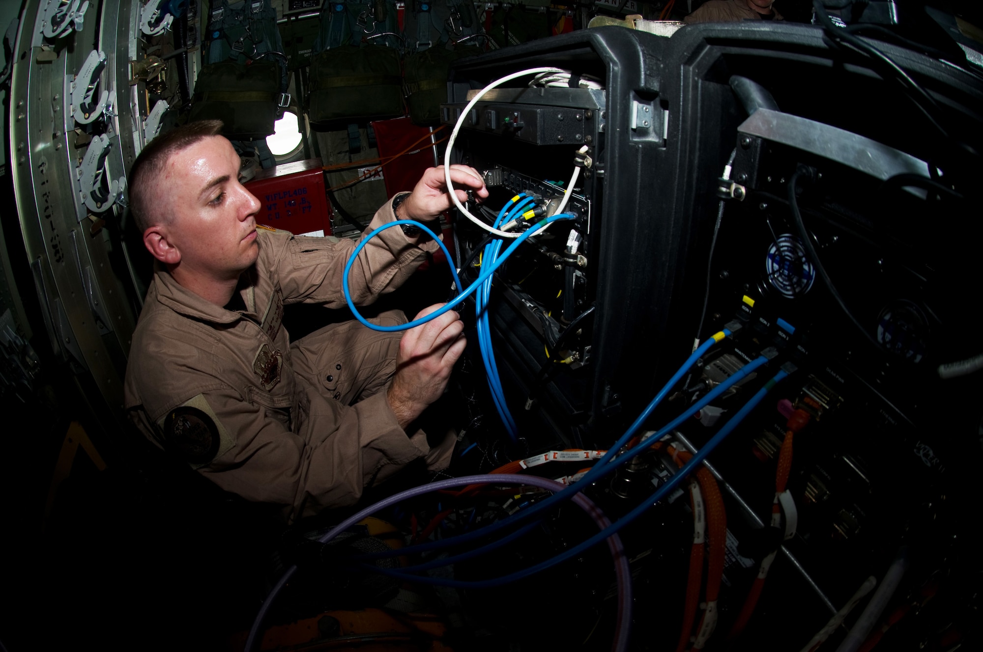 Master Sgt. Donnie Valentine, 379th Expeditionary Communications Squadron viper team member, connects a cord to a ground network operations center during a training exercise to hone skills, Aug. 26. The viper team has the capability to provide computer and phone communications on C-17 Globemaster III and C-130 Hercules aircraft for distinguished visitors while traveling throughout the Area of Responsibility. (U.S. Air Force photo/Senior Airman Eric Summers Jr.)