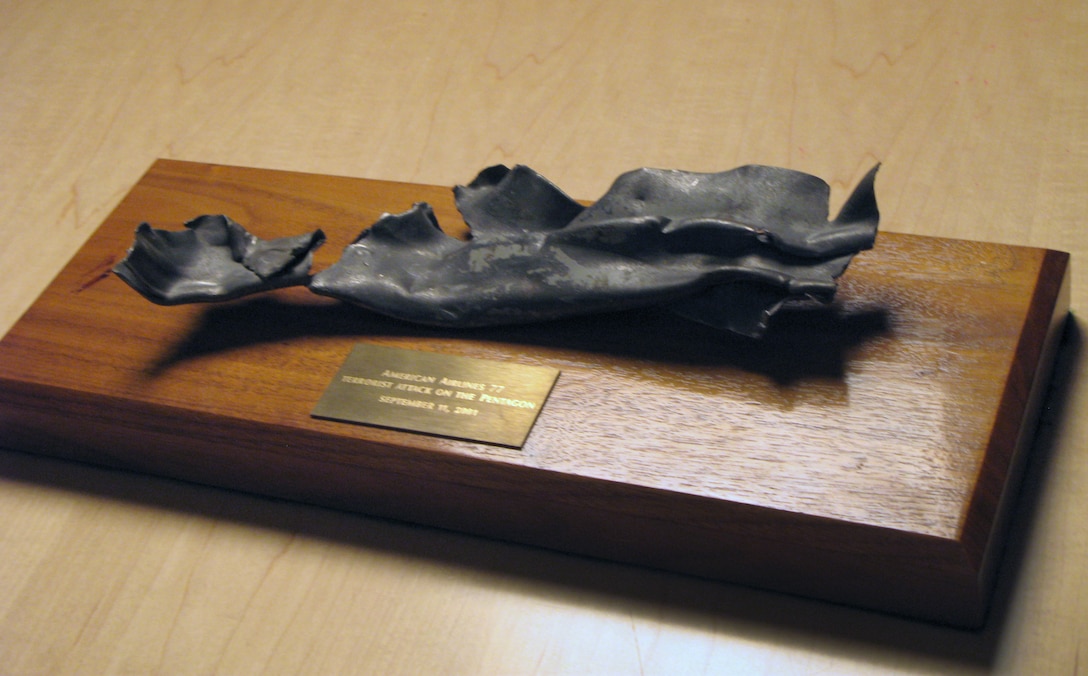 A twisted piece of metal he picked up on the morning of 9/11 from the grounds of the Pentagon at the American Airlines Flight 77 crash site serves as a constant reminder to former Defense Secretary Donald H. Rumsfeld about the need for continued vigilance in standing up to terrorists. DOD photo by Donna Miles