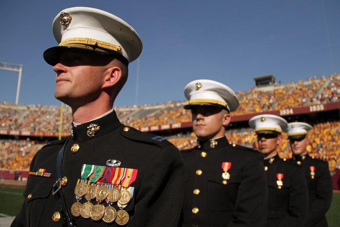 Marine Corps Officer Selection Station Twins Cities Capt. Jacob C. Aldean and 2nd Lts. Nathan Van Otterloo, Tyler Kistner and Steven Nooyen wait to march onto the field for a reaffirmation ceremony at TCF Bank Stadium Sept. 10. The ceremony was part of the Minnesota Gophers halftime show. For additional imagery from the event, visit www.facebook.com/rstwincities.