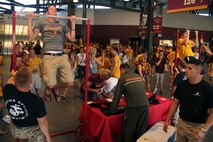 Marine officer candidates and recruiters motivate college students to take the pull-up or flexed-arm hang challenge at TCF Bank Stadium Sept. 10. Three Marine lieutenants from Marine Corps Officer Selection Station Twins Cities reaffirmed their oath of office during the Minnesota Gophers halftime show. For additional imagery from the event, visit www.facebook.com/rstwincities.