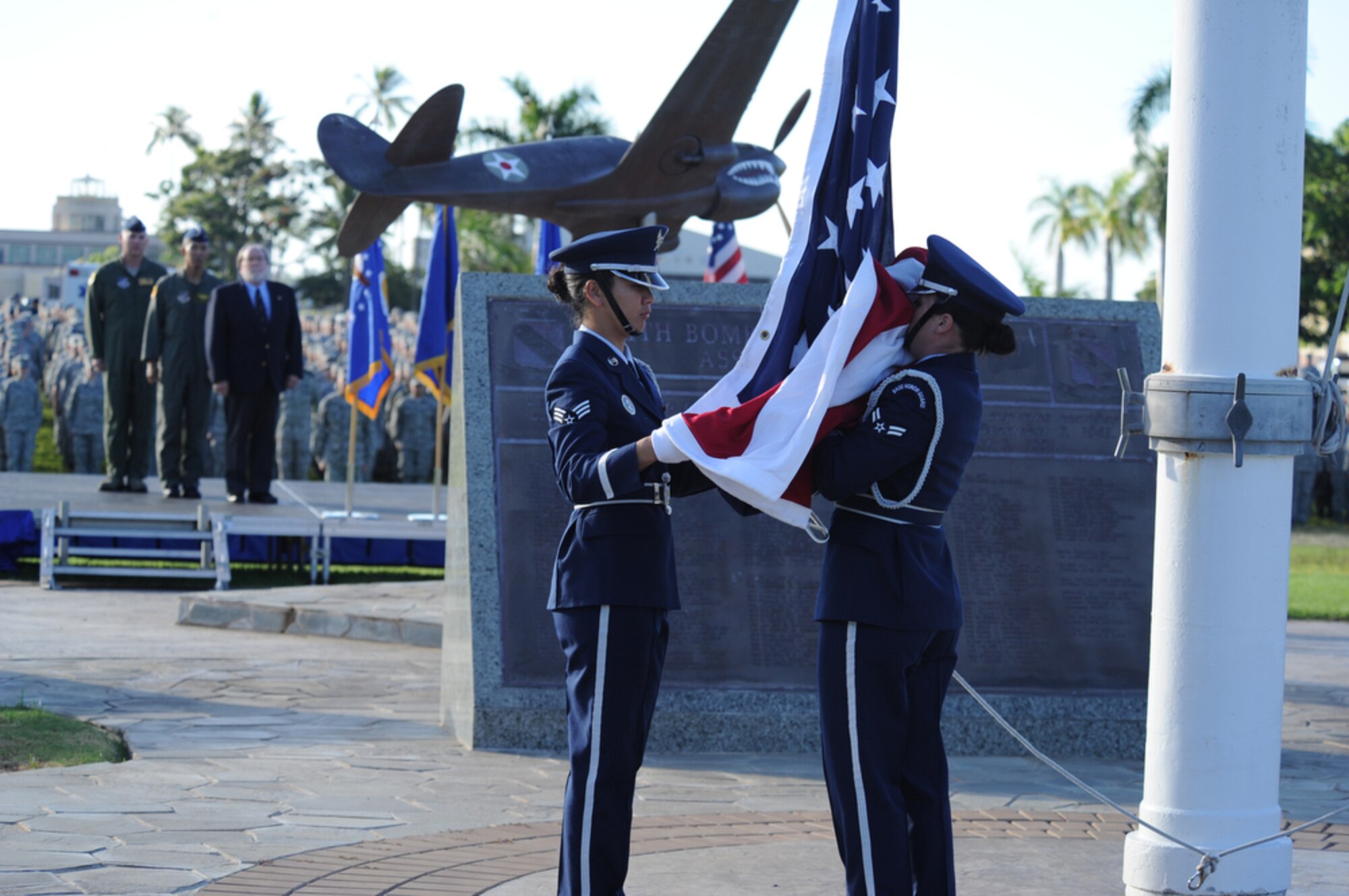 Col. Sam Barrett, Hawaii National Guard Deputy Adjutant General Brig. Gen. Joseph Kim and Gov. Neil Abercrombie watch as two honor guard members raise the flag during a 9/11 tribute ceremony Sept. 9, 2011, at Joint Base Pearl Harbor-Hickam, Hawaii. Barrett is the 15th Wing commander. (Defense Department photo/Master Sgt. Cohen A. Young)