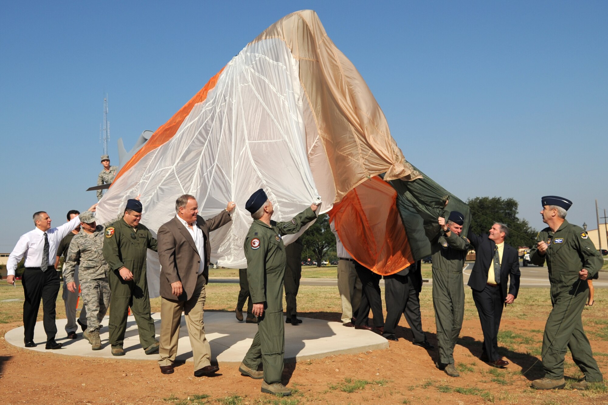 Past and present B-52 bomber aircrew members, led by U.S. Air Force Brig. Gen. John J. Mooney III, 307th Bomb Wing commander, participate in the unveiling of the Conventional Air Launched Cruise Missile (CALCM) monument at Barksdale Air Force Base, La., Sept. 9, 2011. The monument is dedicated to the CALCM weapons system and its history with the B-52. (U.S. Air Force photo by Master Sgt. Greg Steele/Released)