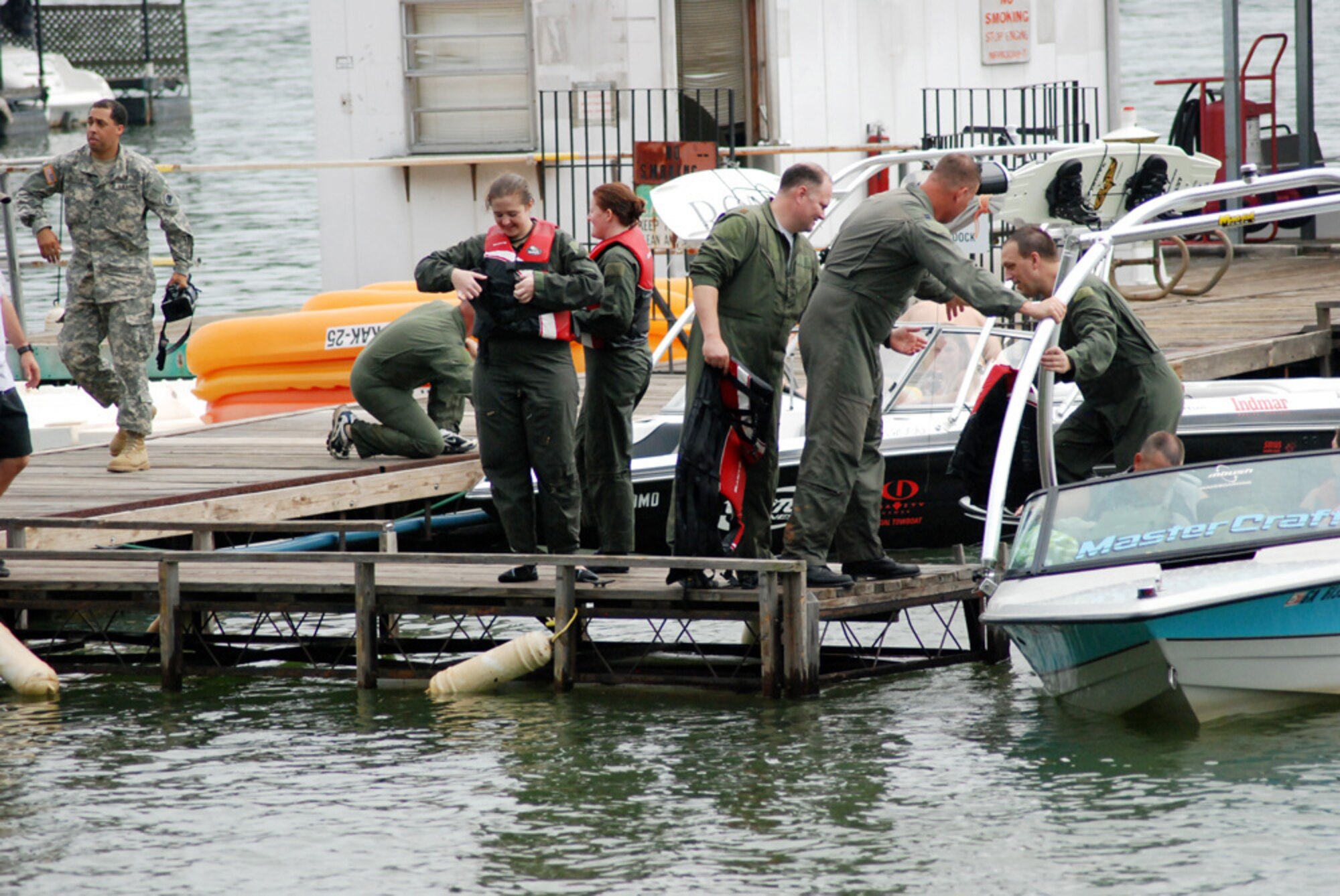 Participants from 700th Airlift Squadron, 94th Airlift Wing, and 94th Aeromedical Evacuation Squadron, the water survivor training exercise put on their life vest before loading onto boat which will takes them to their target site. (U.S. Air Force photo/Master Sgt. Travon Dennis)