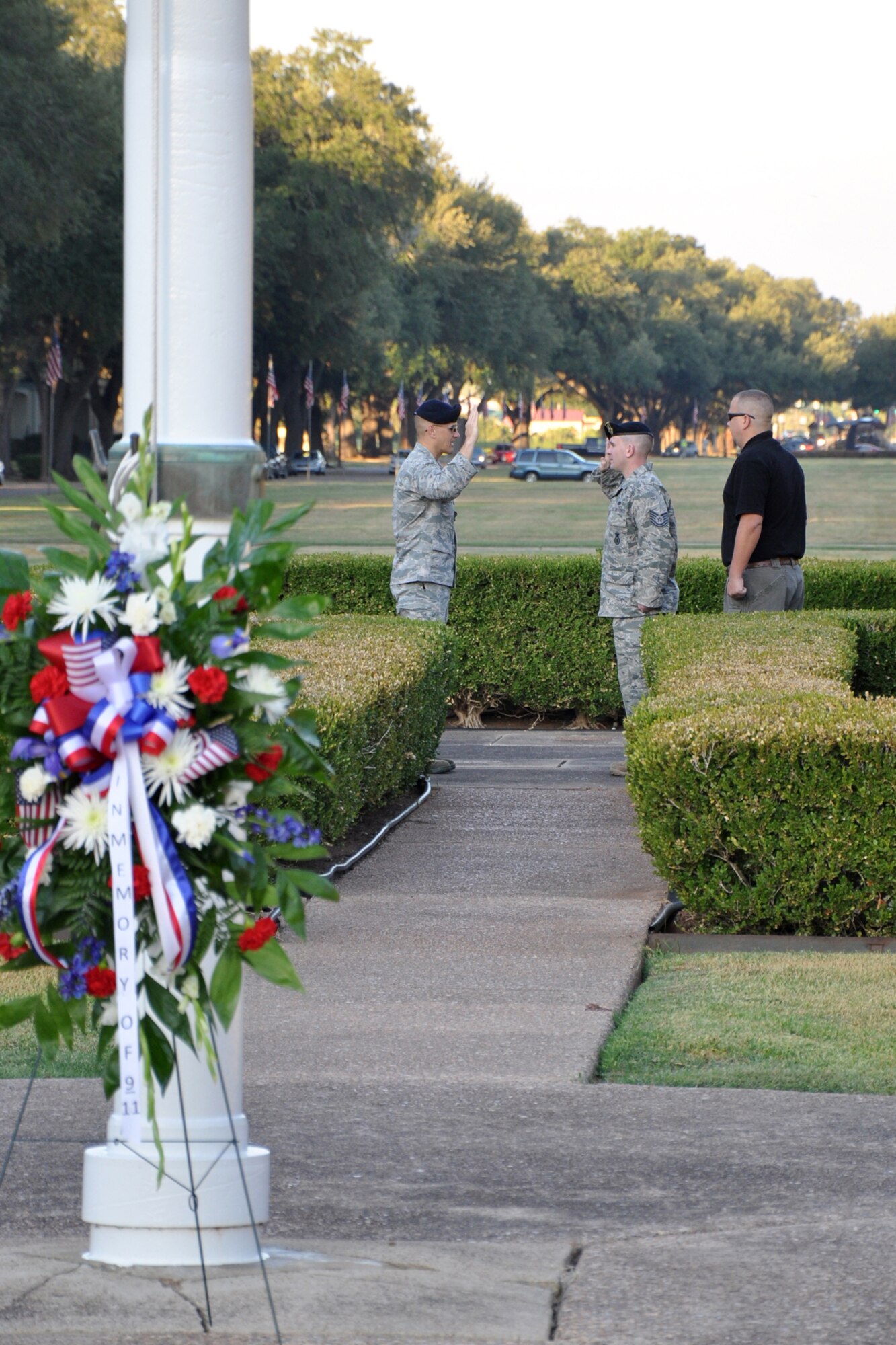 Lt. Col. Jonpaul Mickle, the commander of the 2nd Security Forces Squadron, re-enlists Tech. Sgt. Andrew Hallead, at the flag pole in front of the 2nd Bomb Wing Headquarters building after the 9/11 Remembrance Ceremony at Barksdale Air Force Base, La., Sept. 9, 2011. Hallead's good friend Monte Jones, who is also assigned to the 2nd SFS was there to witness the event . (U.S. Air Force photo by Tech. Sgt. Jeff Walston/Released)