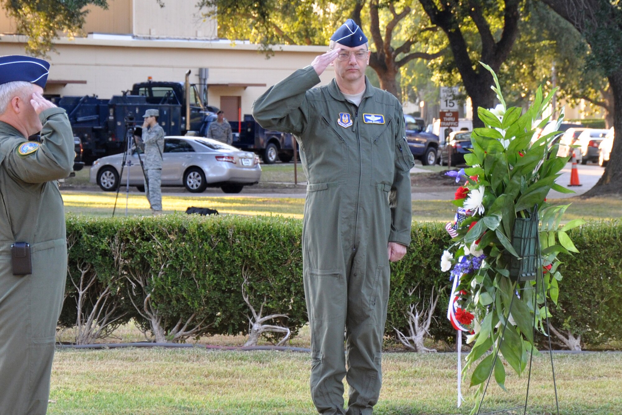 Brig. Gen. John J. Mooney III, the commander of the 307th Bomb Wing, pays his respects after flowers are placed at the base of the flag pole in front of the 2nd Bomb Wing Headquarters building during the 9/11 Remembrance Ceremony at Barksdale Air Force Base, La., Sept. 9, 2011. The ceremony, which included the singing of the Star-Spangled Banner and the placing of the flowers, also included a moment of silence for reflection of the losses, both military and civilian since Sept. 11, 2001. (U.S. Air Force photo by Tech. Sgt. Jeff Walston/Released)