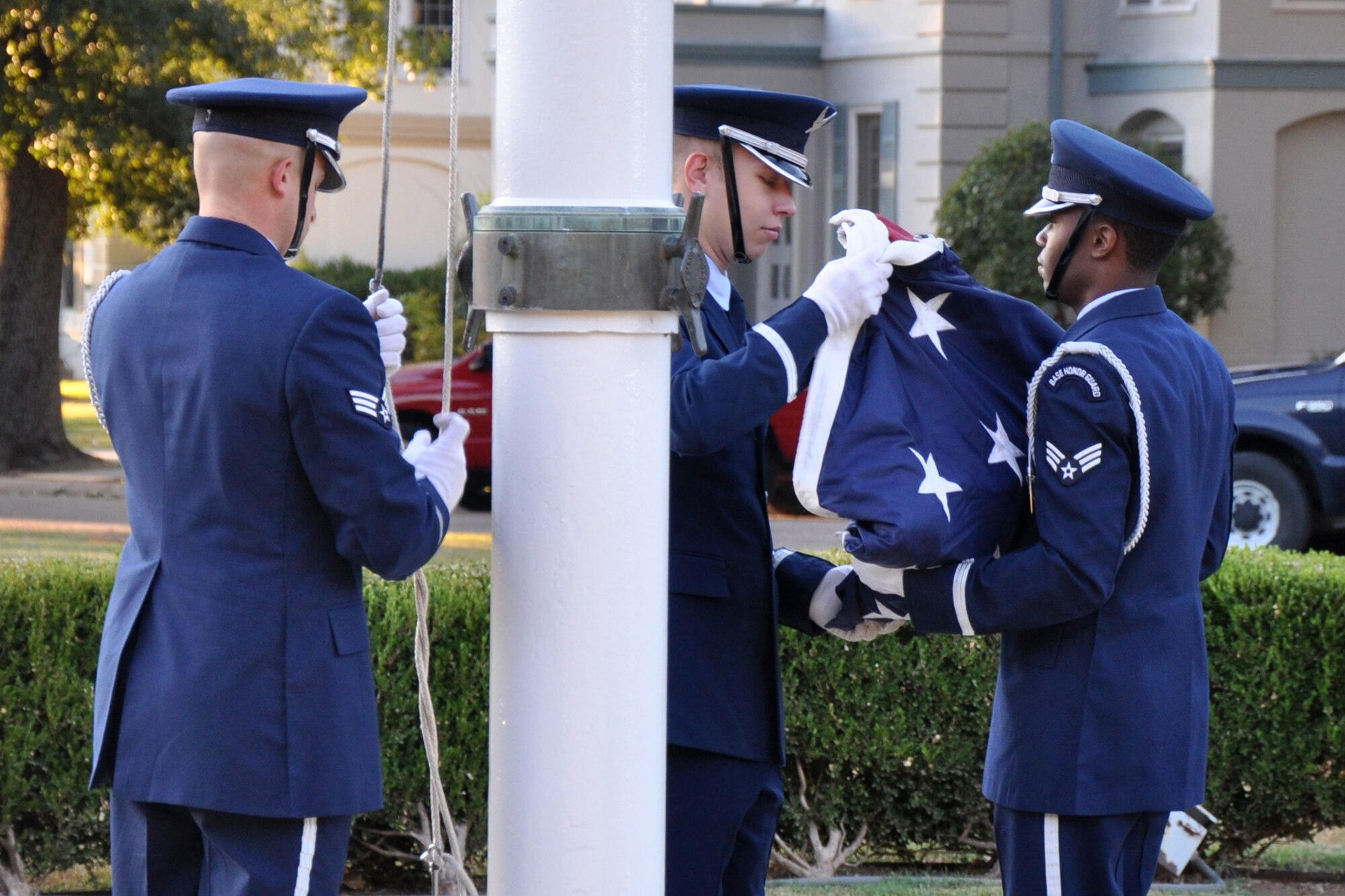Members of the Barksdale Base Honor Guard raise, then lower the American Flag to half-staff during the 9/11 Remembrance Ceremony at Barksdale Air Force Base, La., Sept. 9, 2011. (U.S. Air Force photo by Tech. Sgt. Jeff Walston/Released)