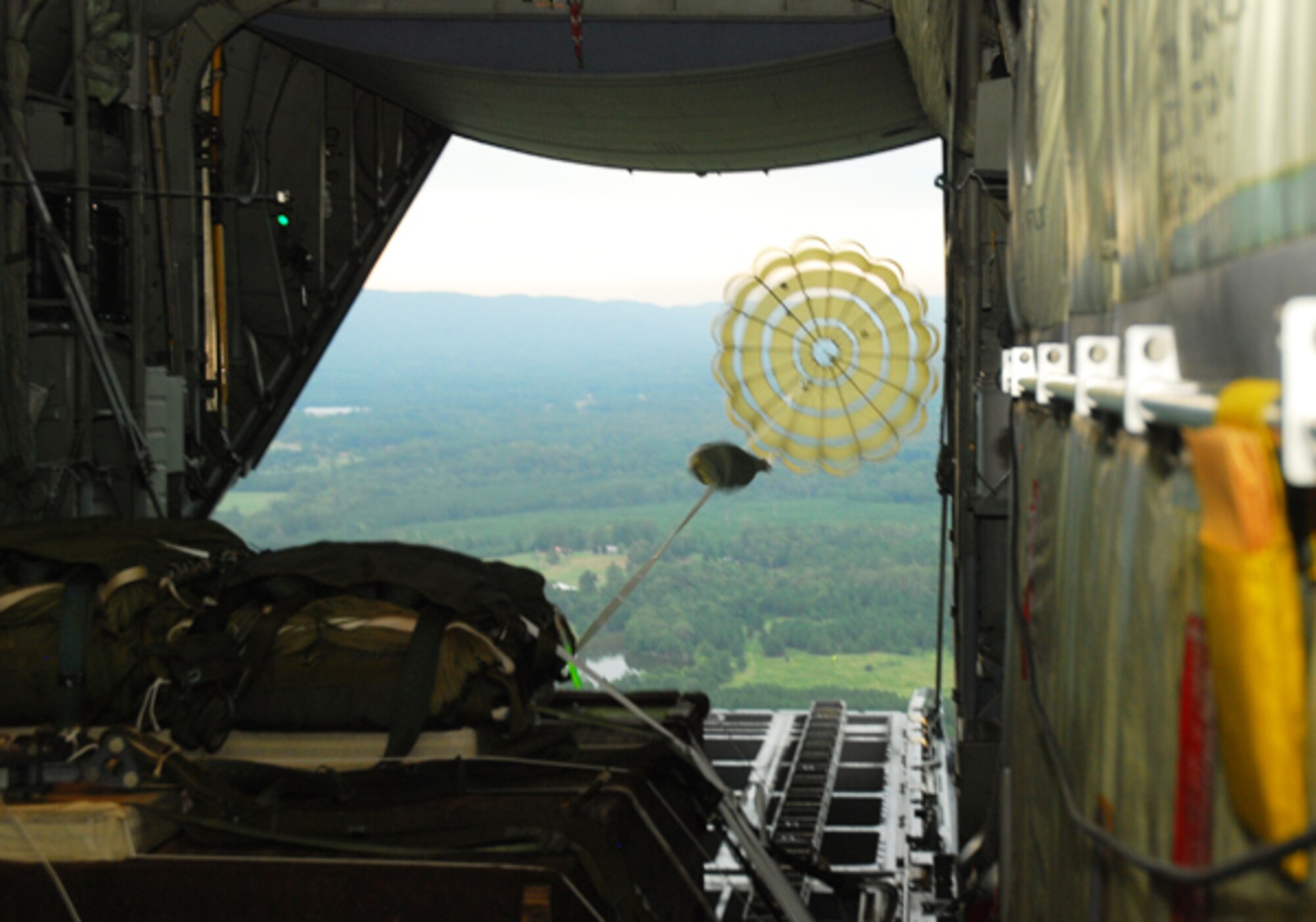 A bundle of container delivery systems is released above the north Georgia Mountains from a C-130H aircraft for training held on Aug. 10. The four-hour training held Aug. 9 included aerial drops and touch-and-go currency training for the 700th Airlift Wing. (U.S. Air Force photo/Airman 1st Class Chelsea Smith)
