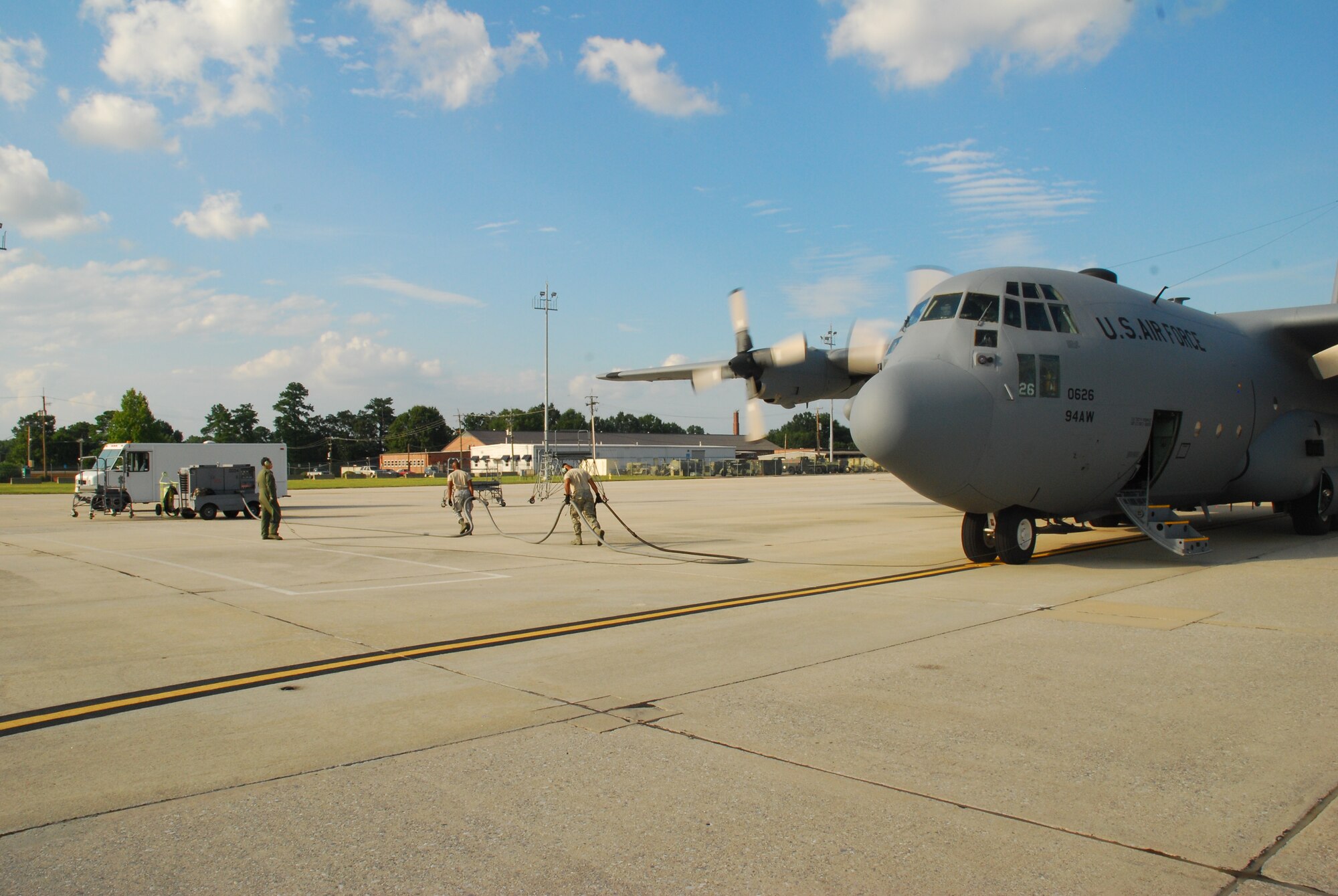 Team members refuel the C-130H aircraft in preparation for training conducted Aug 9. Members from the 700th Airlift Squadron dropped loads of container delivery systems to satisfy currency training. (U.S. Air Force photo/Airman 1st Class Chelsea Smith)