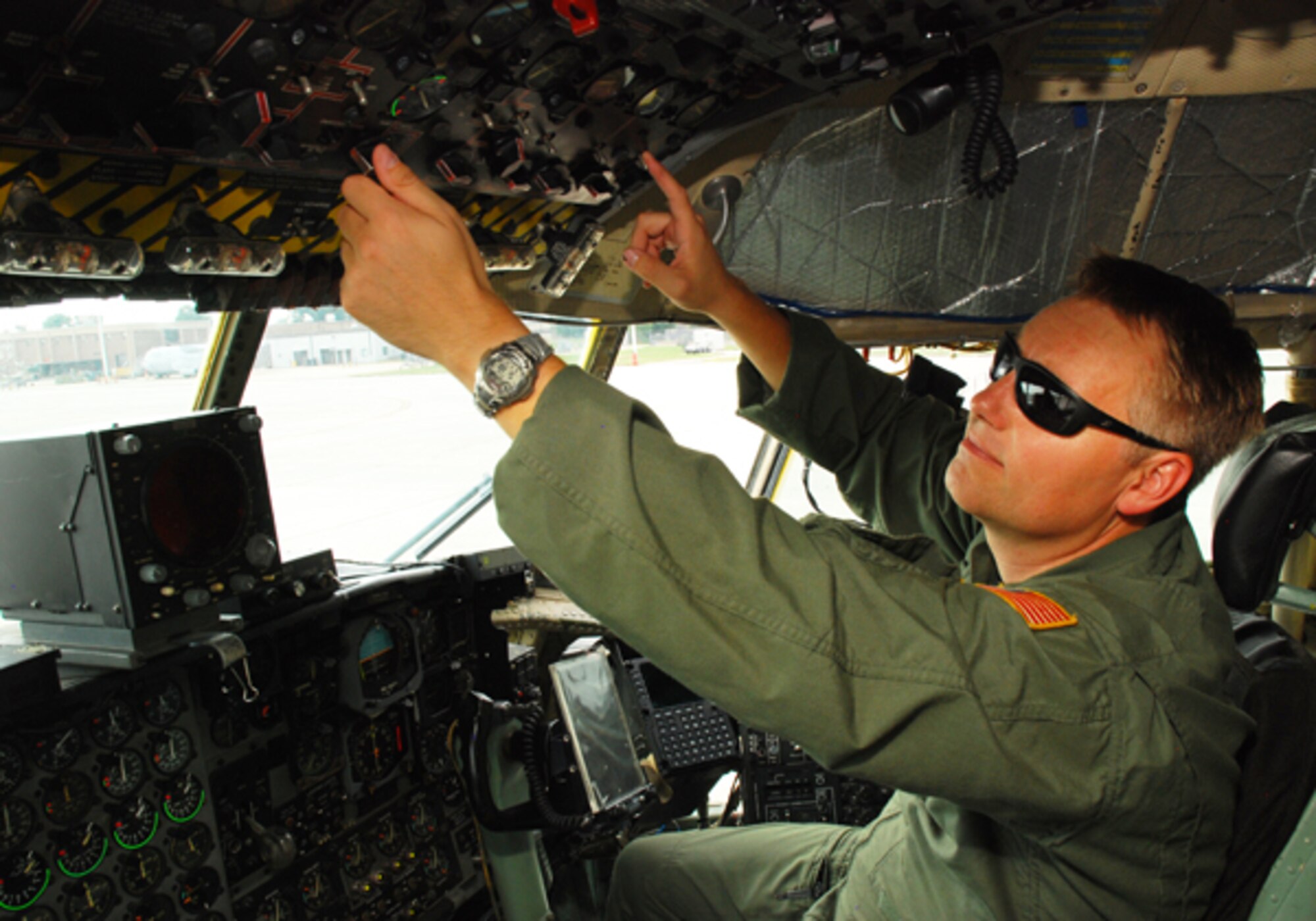 Staff Sgt. Chris Garey performs a pre-flight check to ensure aircraft systems are operating normally before a flight exercise in the C-130H Aug. 9. The aerial drops were conducted for currency training for the 700th Airlift Squadron here. (U.S. Air Force photo/Airman 1st Class Chelsea Smith)