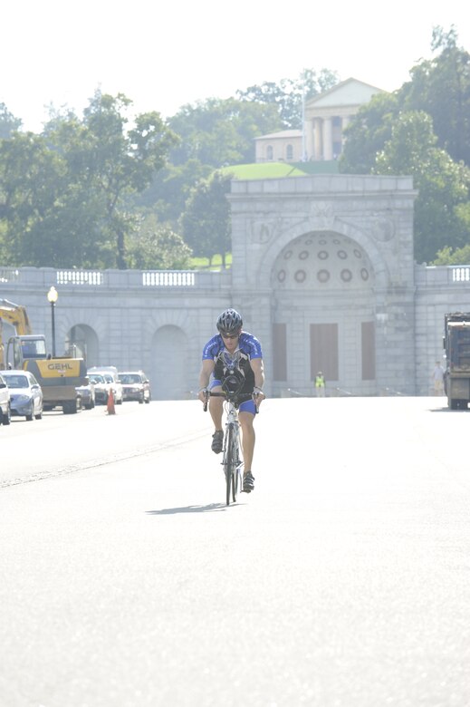 Capt. Chris Pace, 58th Airlift Squadron instructor pilot, Altus Air Force Base, Okla., warms up in front of the Women in Service Memorial, Arlington, Va. Sept. 9 before departing on his 250-mile journey to N.Y.C. Pace is slated to complete a cross fit challenge Sept. 9-11 beginning at Arlington National Cemetery, Va., and ending at Ground Zero in New York City, without stopping to rest. Pace is calling his athletic quest the “Journey of Freedom” and he is doing it in support of The Disposable Heroes Project, which is a non-profit organization that supports wounded and fallen warriors and their families. (U.S. Air Force photo by Staff Sgt. Raymond Mills) 